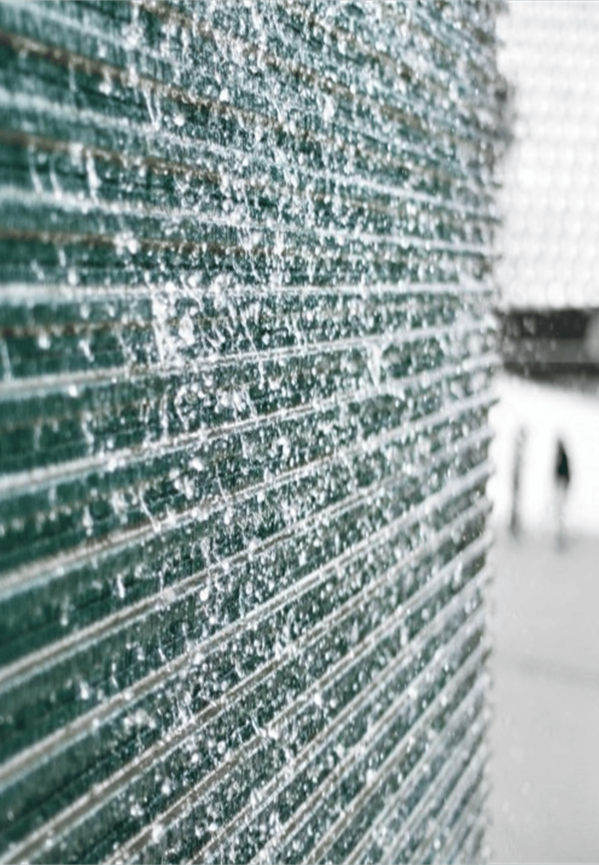 an abstract photo of a curved building with a blue sky in the background