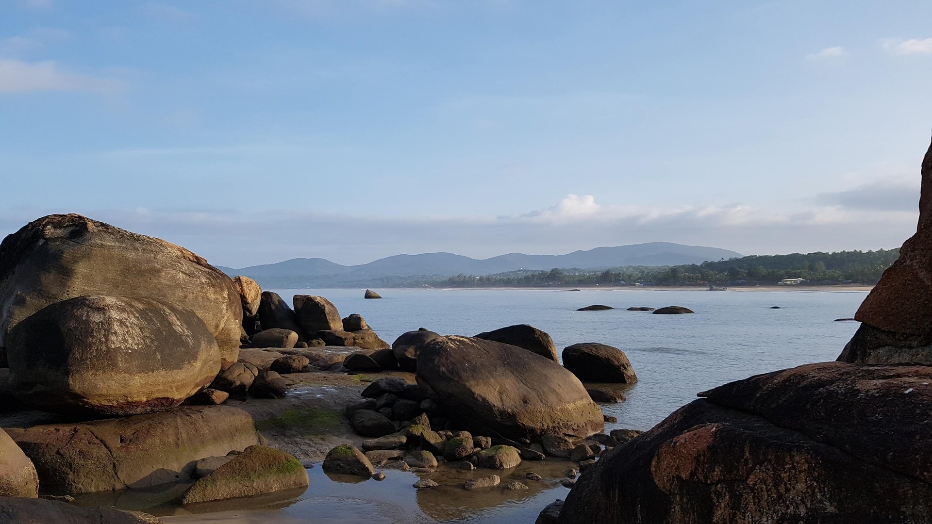 an abstract photo of a curved building with a blue sky in the background
