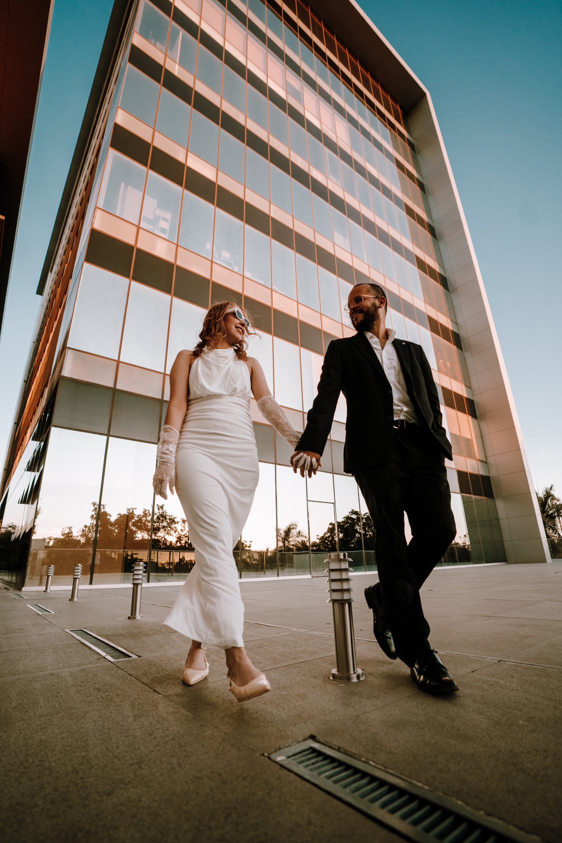 an abstract photo of a curved building with a blue sky in the background