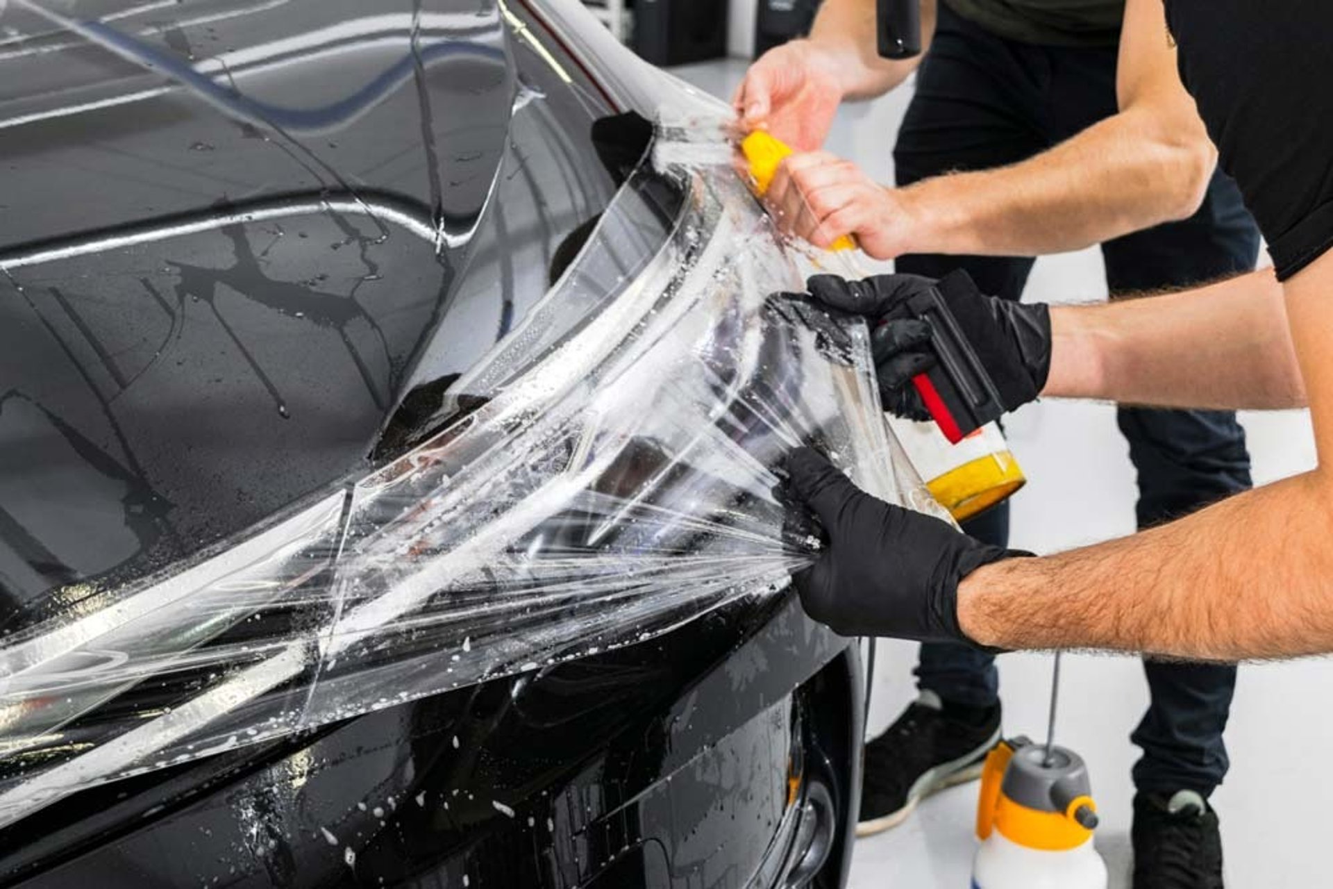 a man waxing the hood of a car