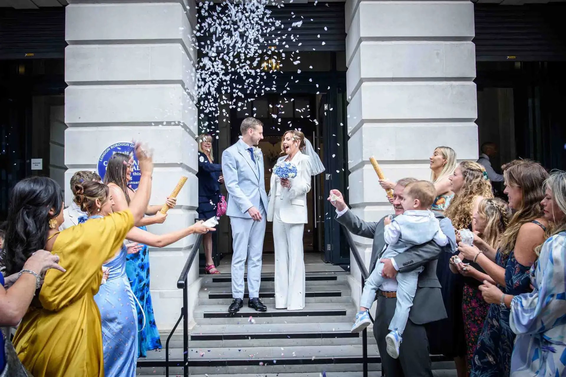 wedding couple on the steps of Camden Town Hall