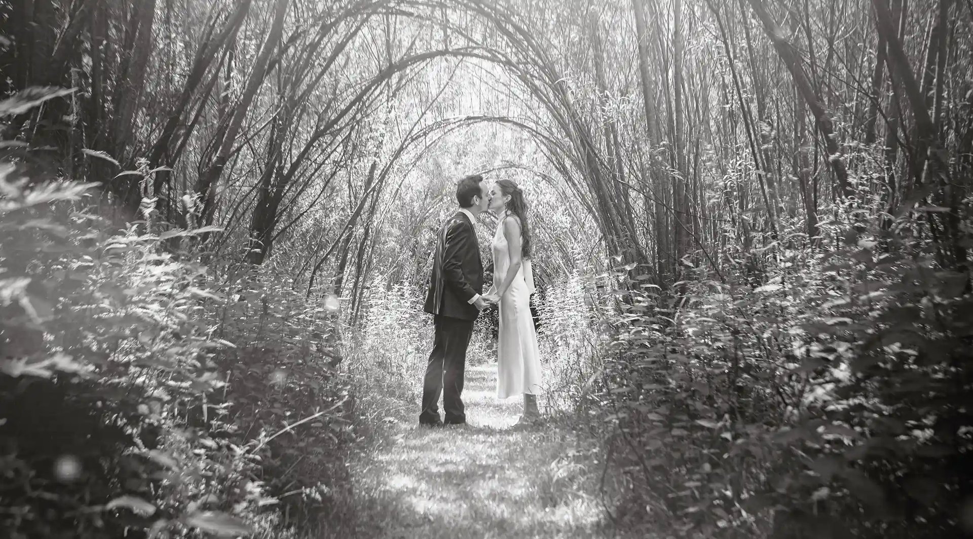 Jenny and Alfie sharing a kiss before their wedding ceremony