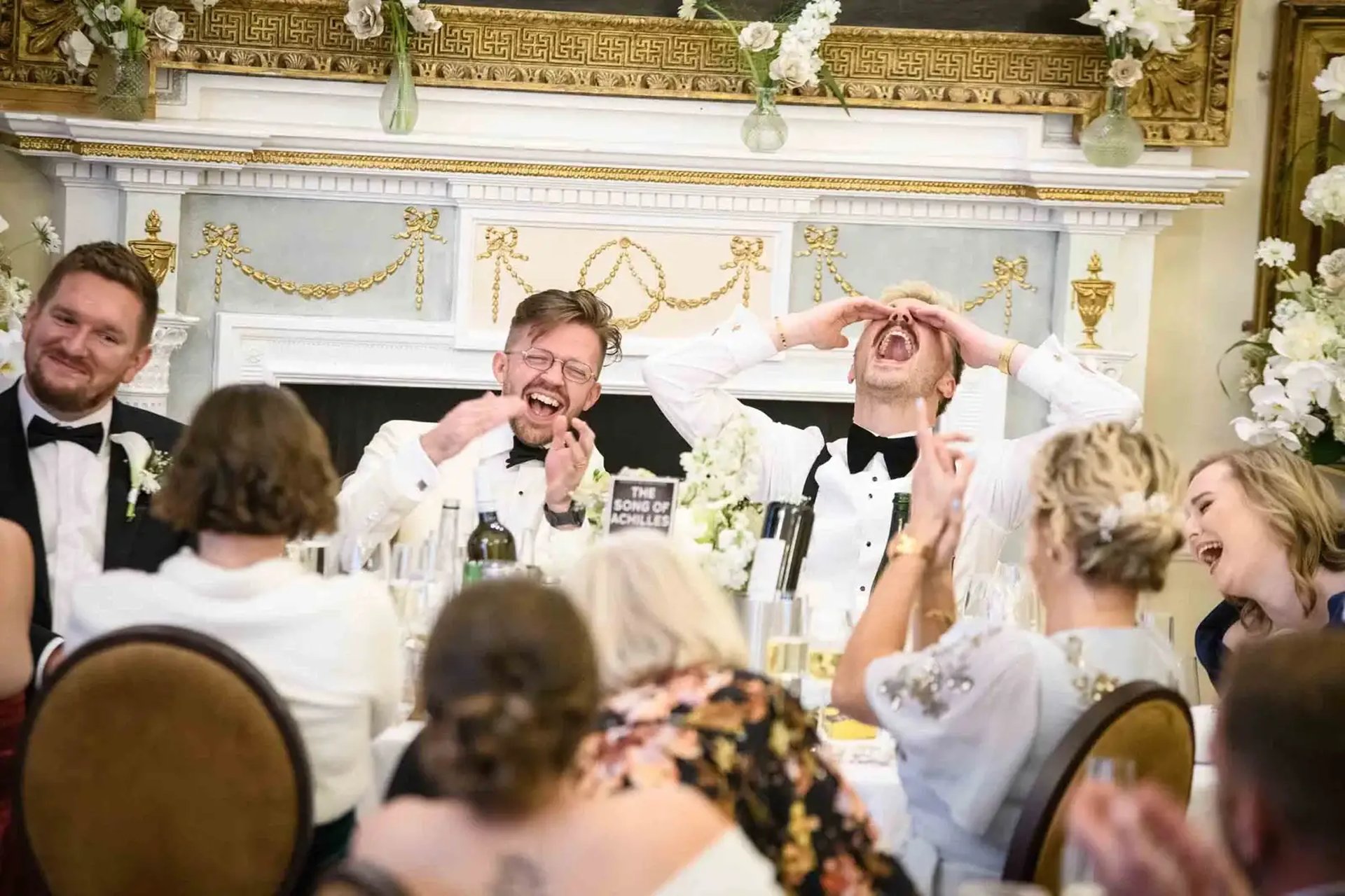 same-sex couple enjoying speeches after their wedding at The Trafalgar Tavern Greenwich