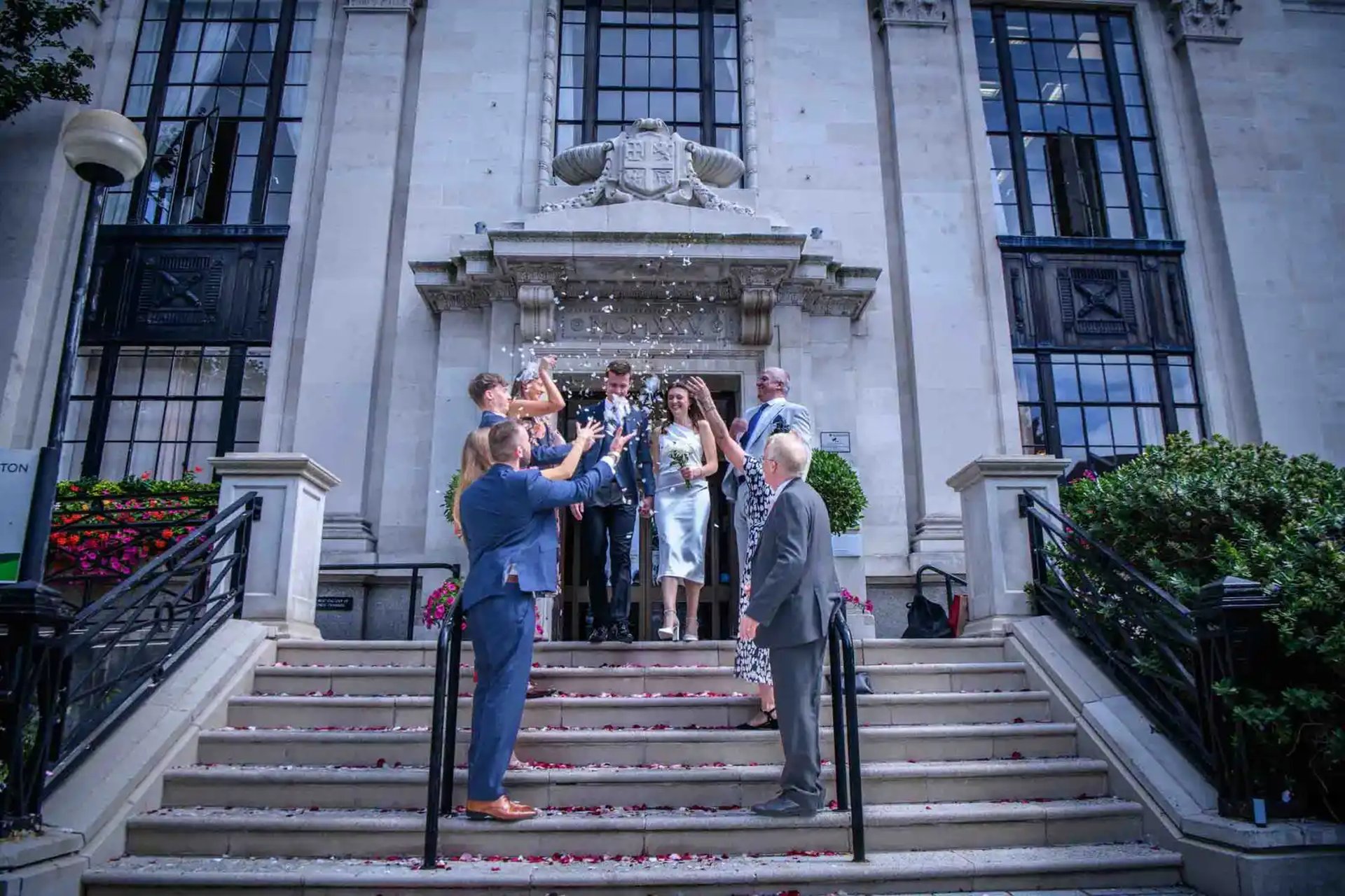 wedding couple having their confetti moment outside Islington Town Hall