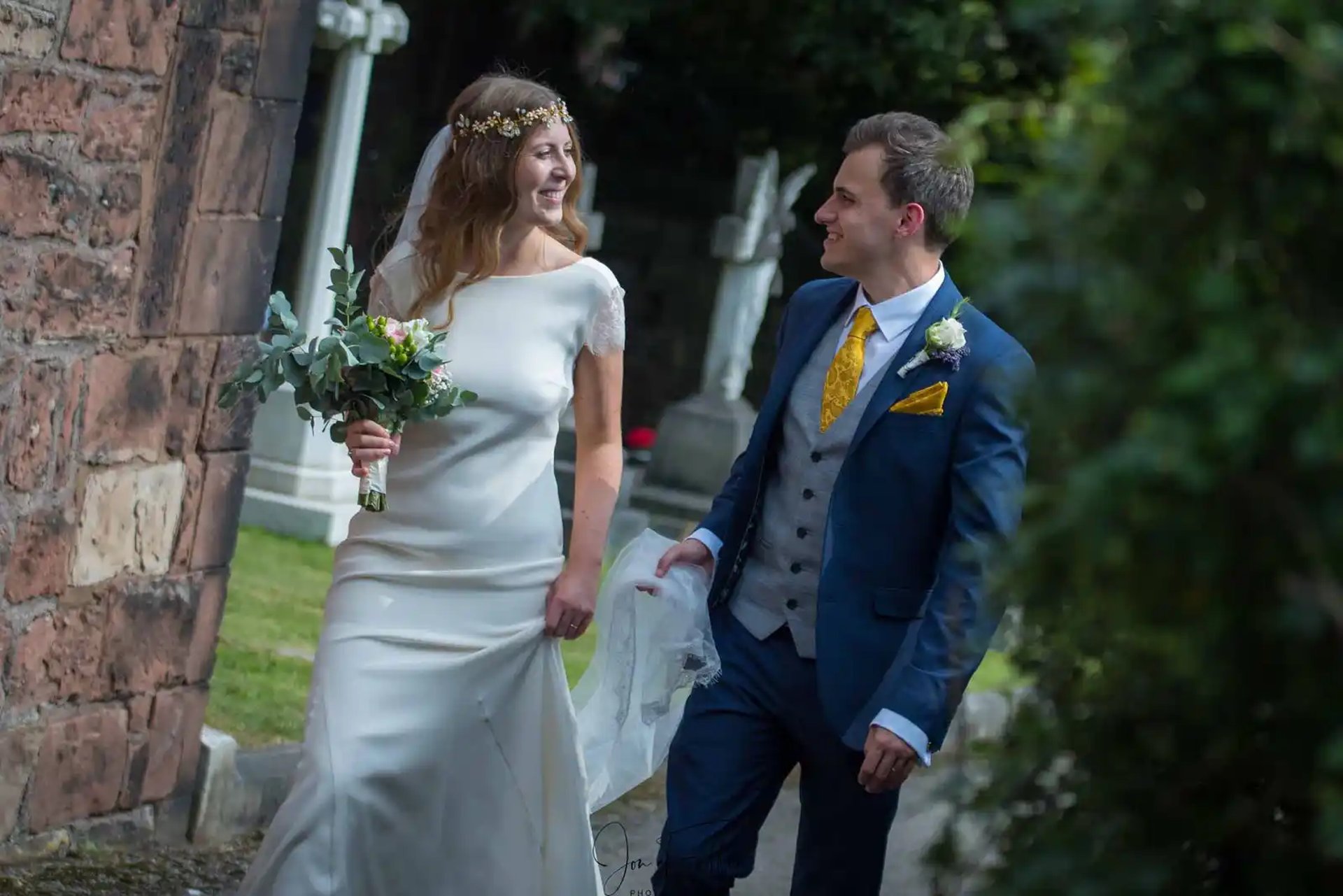 bride and groom walking around church grounds