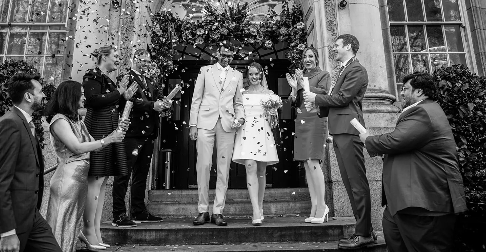 wedding couple walking down the stairs of Chelsea old town hall