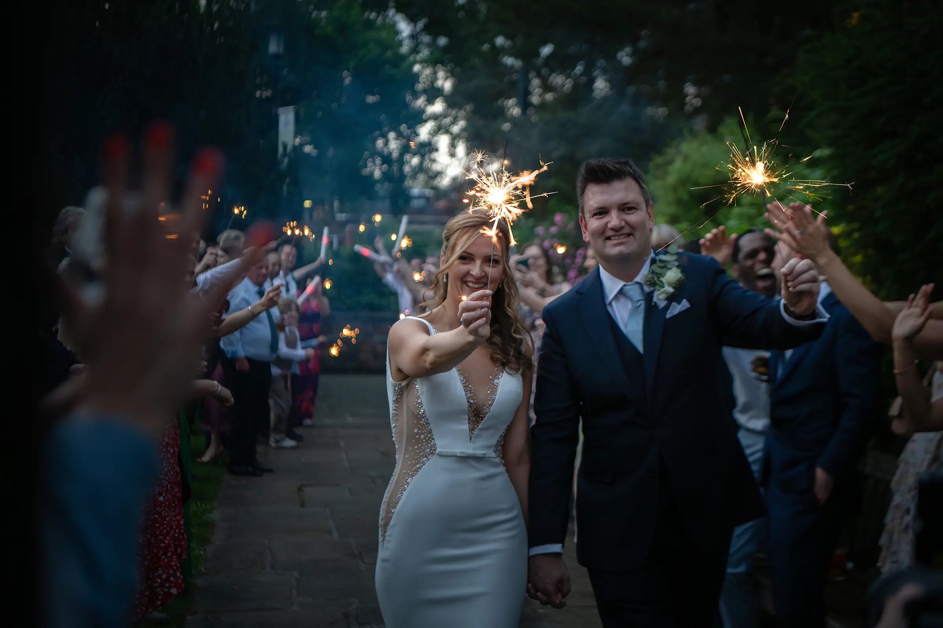 bride and groom holding sparklers