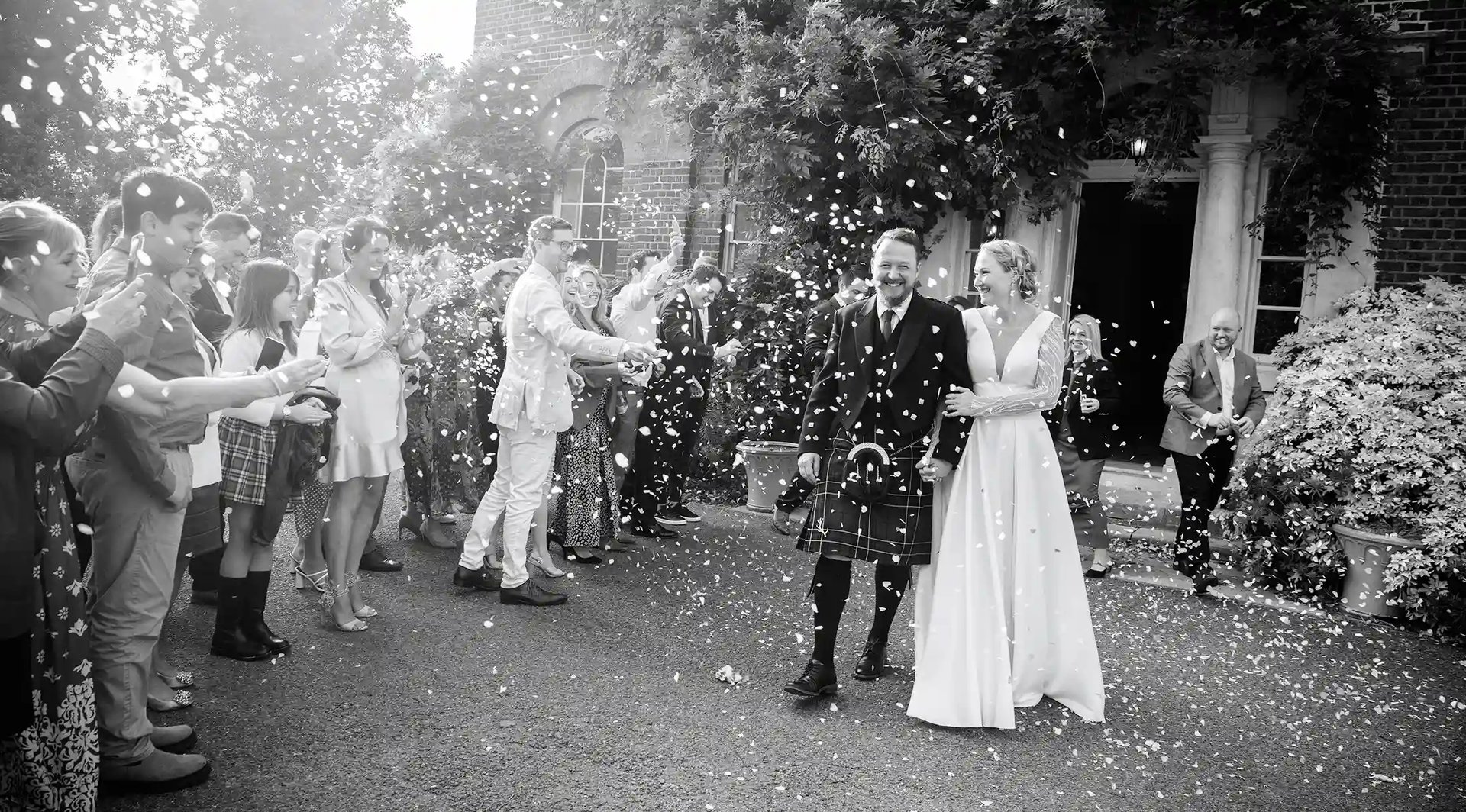 Isabella and Doug having a confetti moment outside Morden Park House