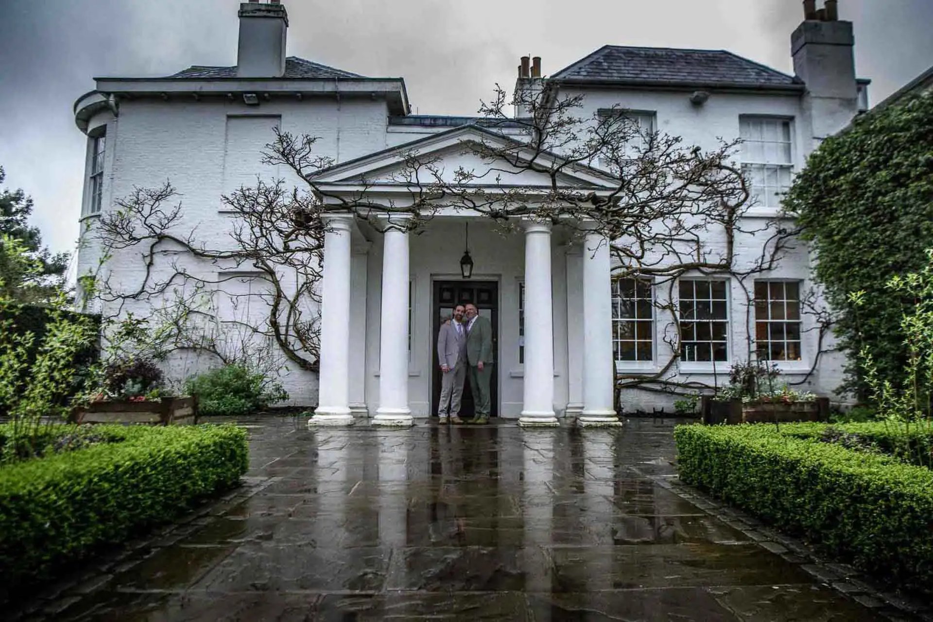 two grooms standing at the front door of Pembroke Lodge, Richmond