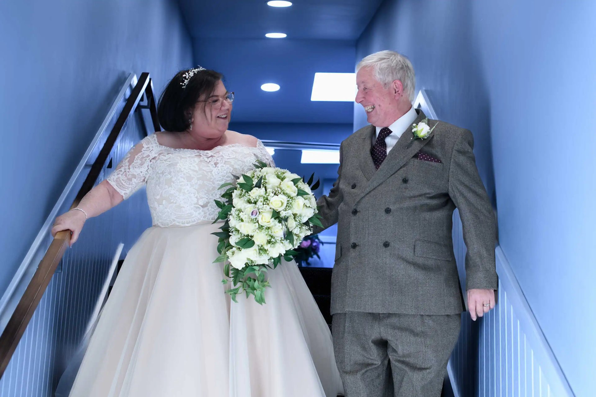 wedding couple walking down stairs