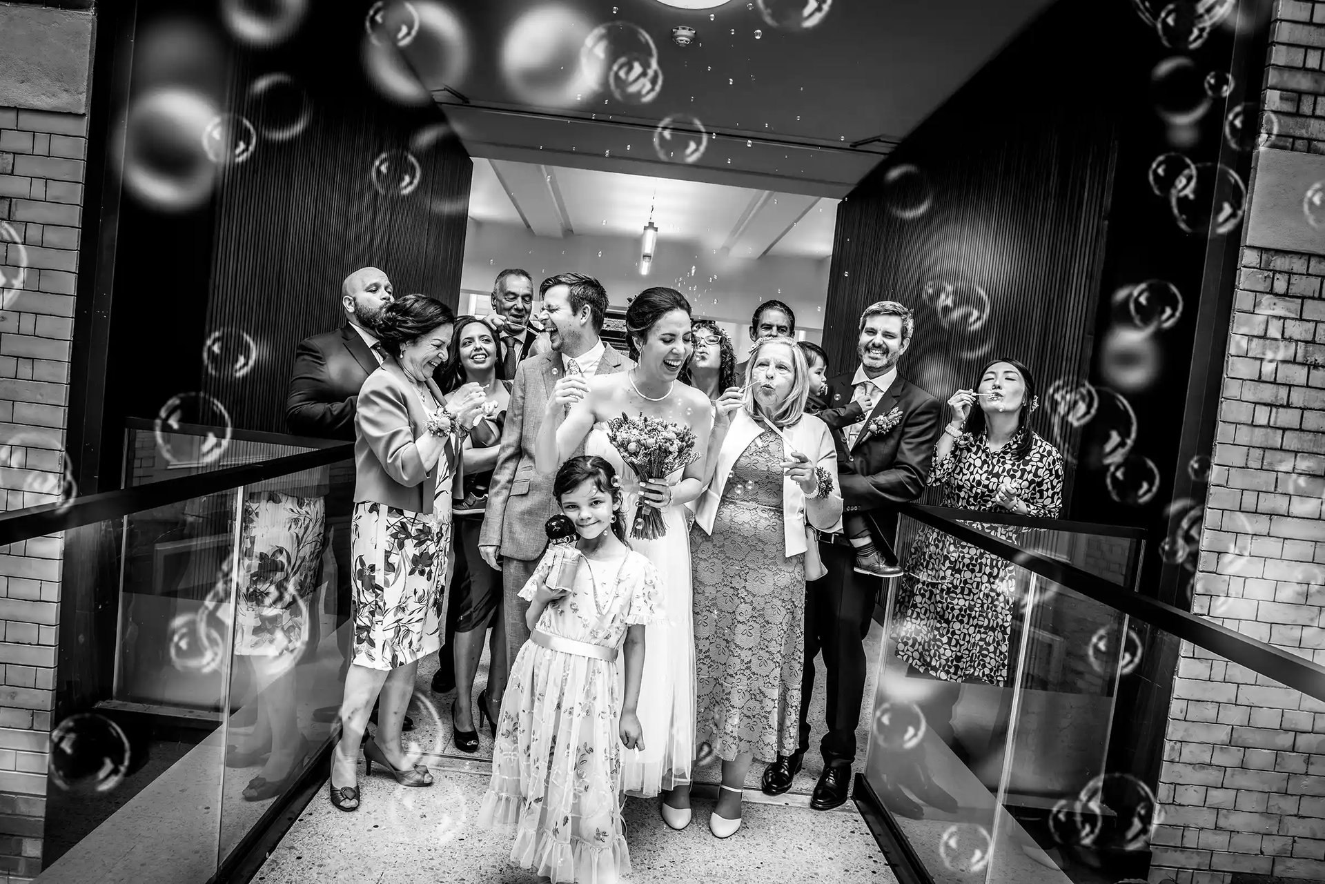 Ben and Patricia with bubbles on the internal bridge at Lambeth Town Hall