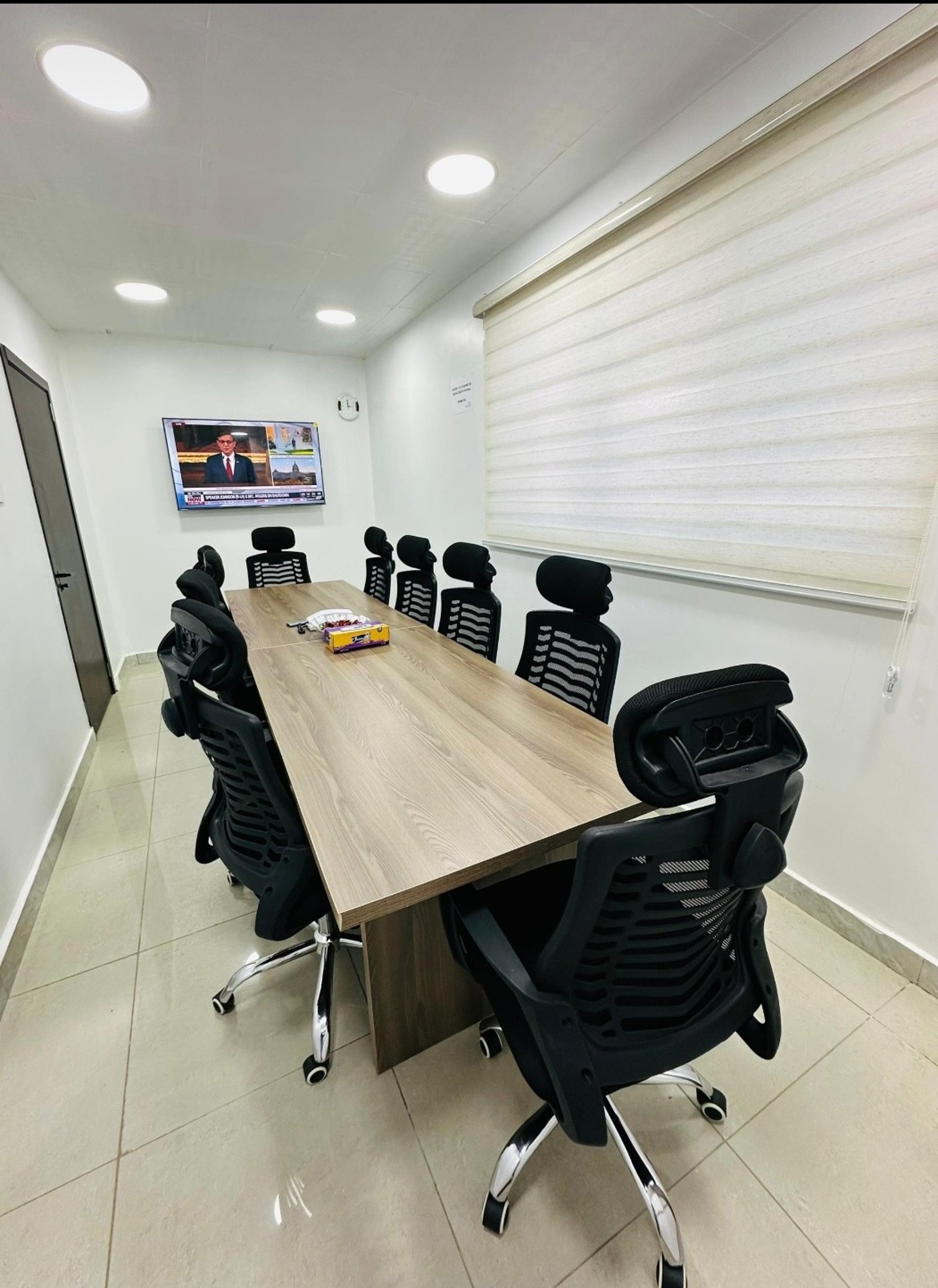 black flat screen tv turned on near green plant