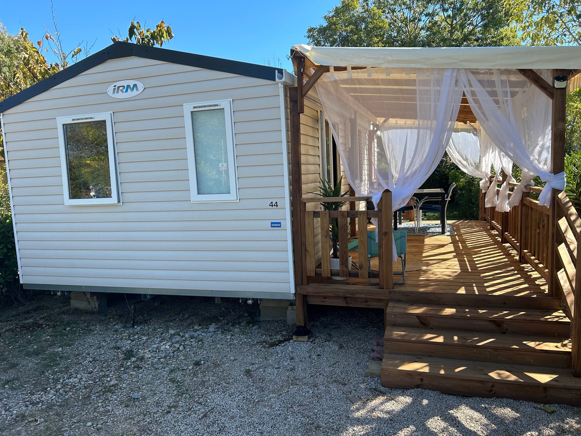brown wooden table and chairs on brown wooden deck near body of water during daytime
