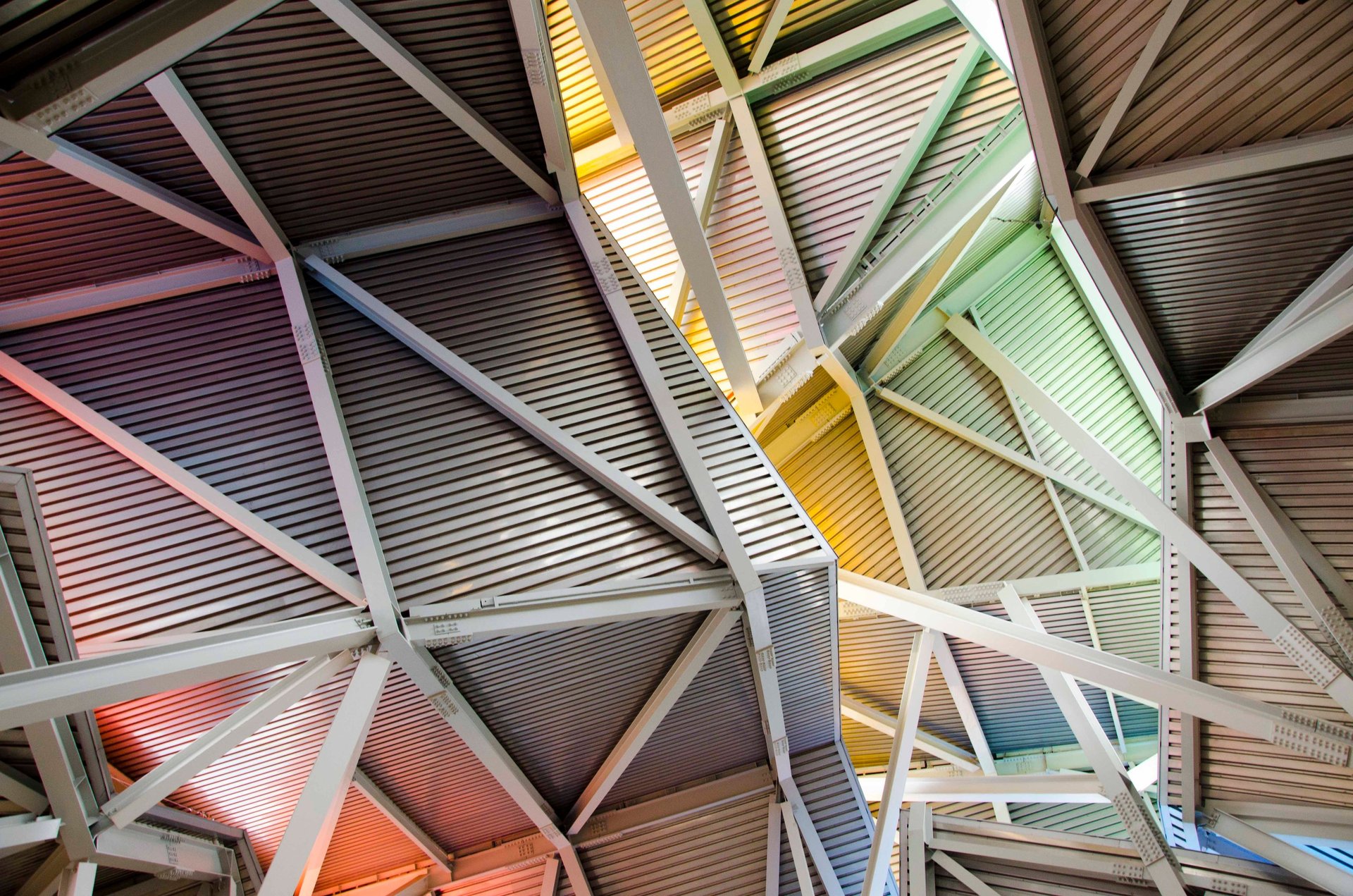 an abstract photo of a curved building with a blue sky in the background