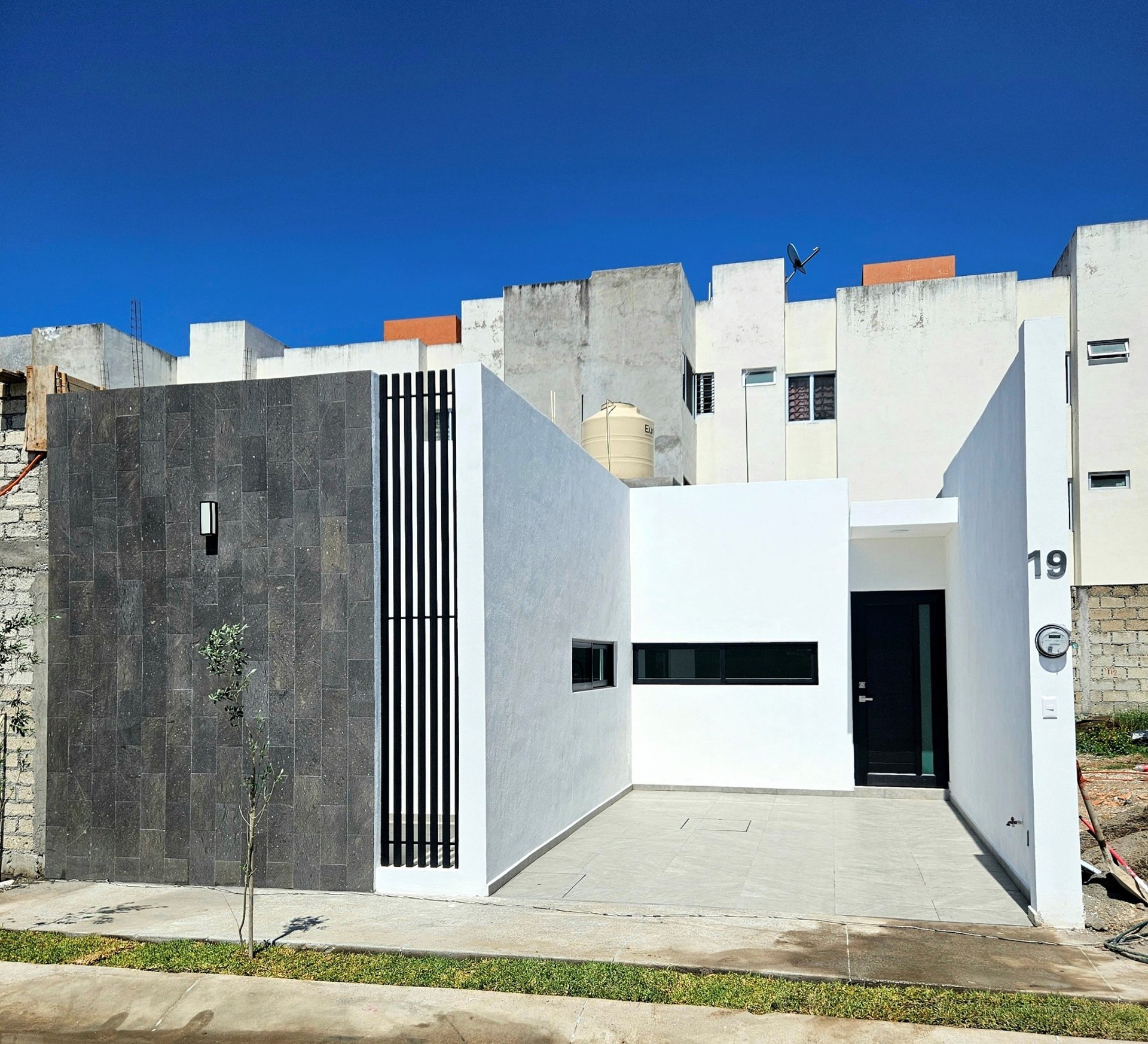 an abstract photo of a curved building with a blue sky in the background