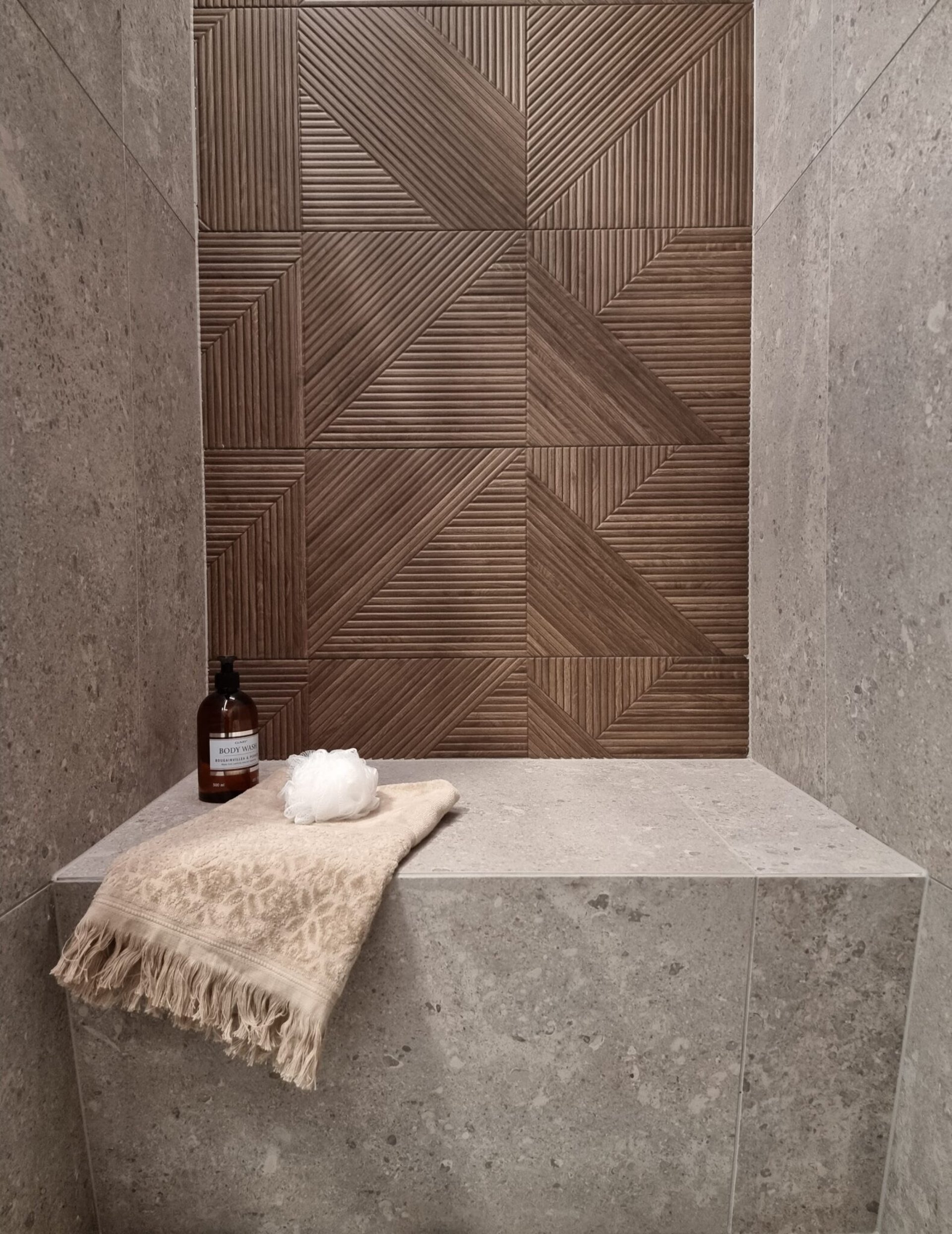 a shadow of a tree on a tile wall