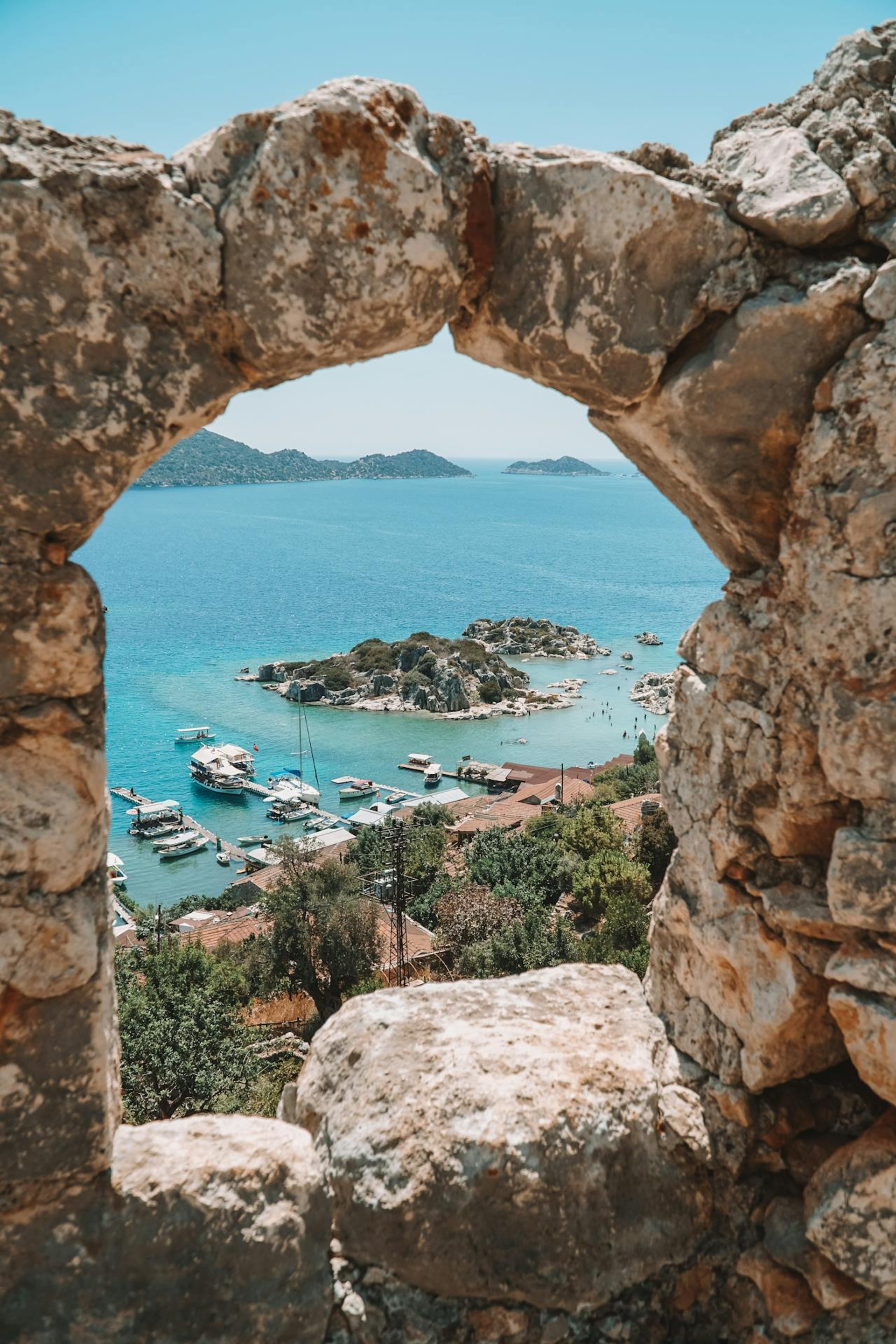 body of calm water near houses and trees during daytime