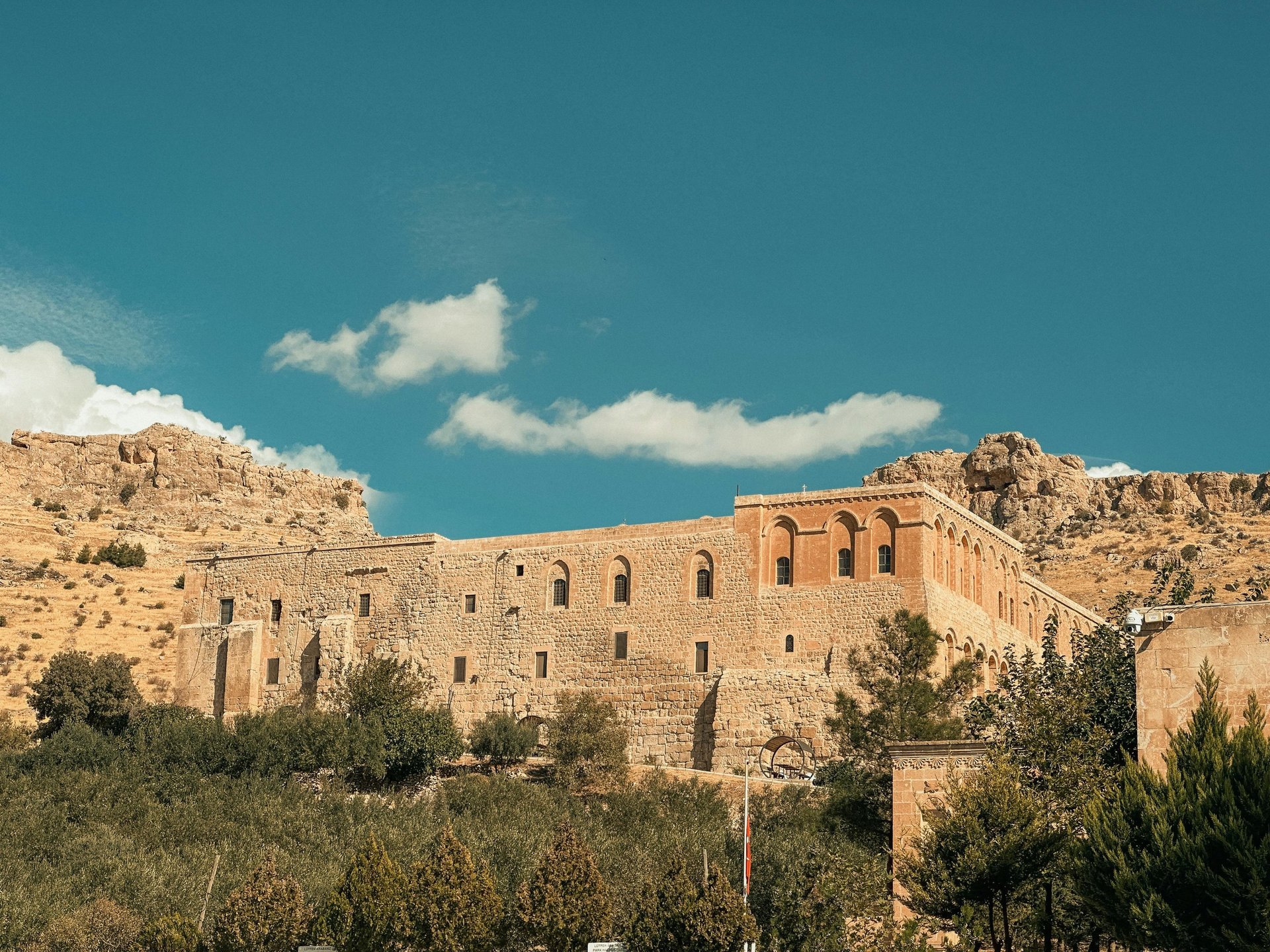 body of calm water near houses and trees during daytime