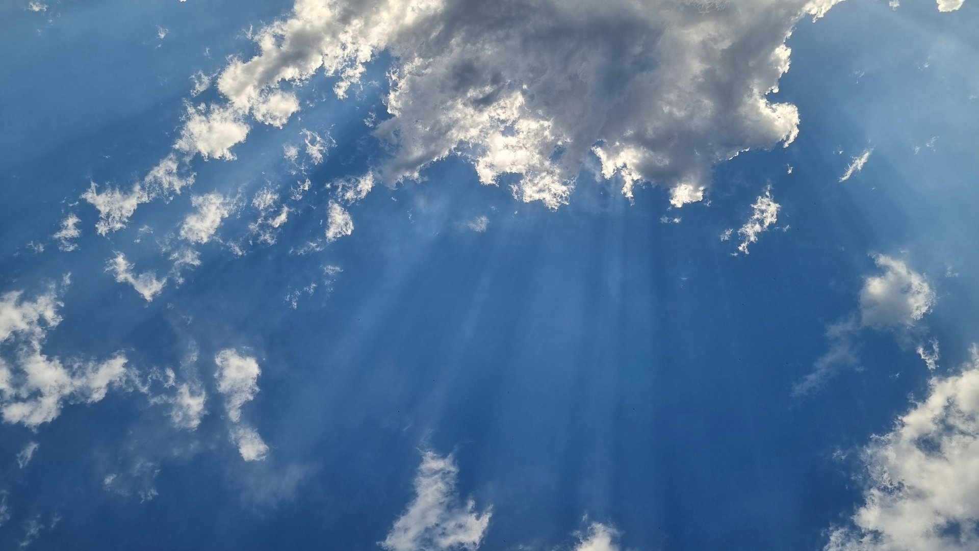 sea under white clouds at golden hour