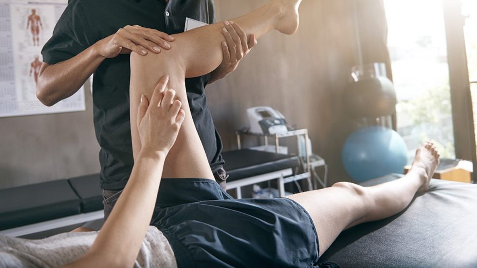 person pressing man back kneeling on blue towel