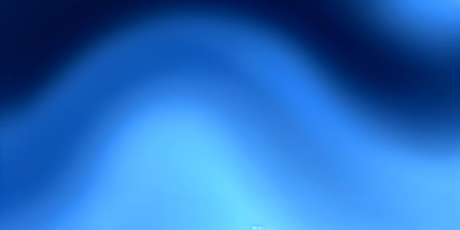 an abstract photo of a curved building with a blue sky in the background