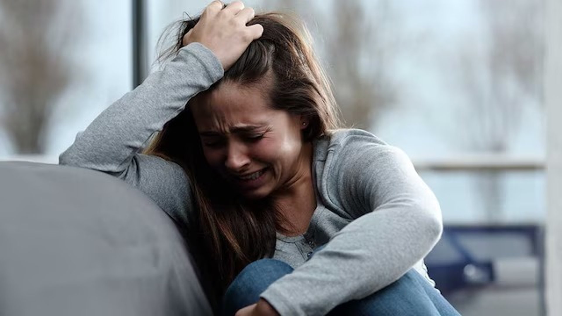 man touching face with both hands