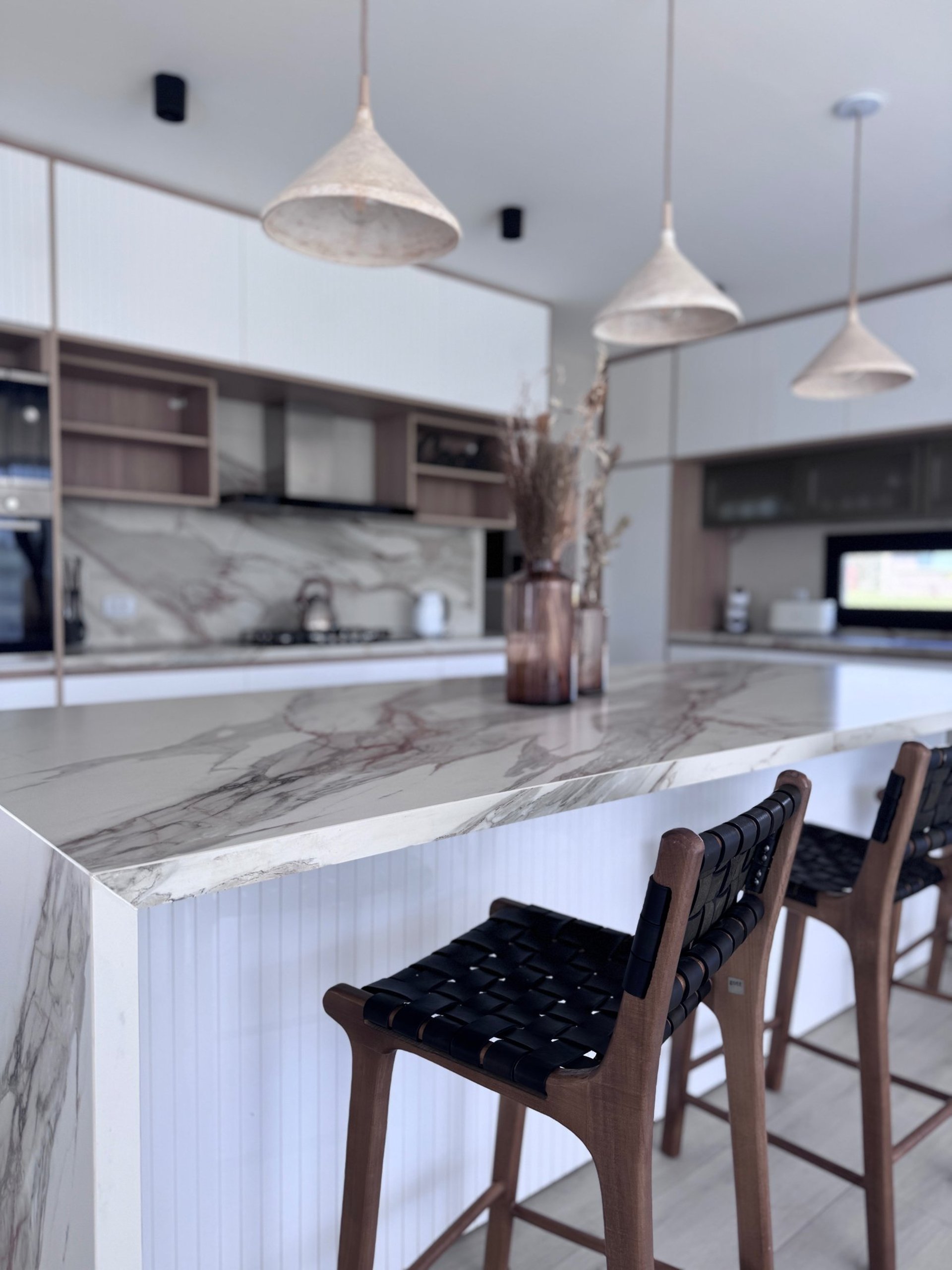 an abstract photo of a curved building with a blue sky in the background