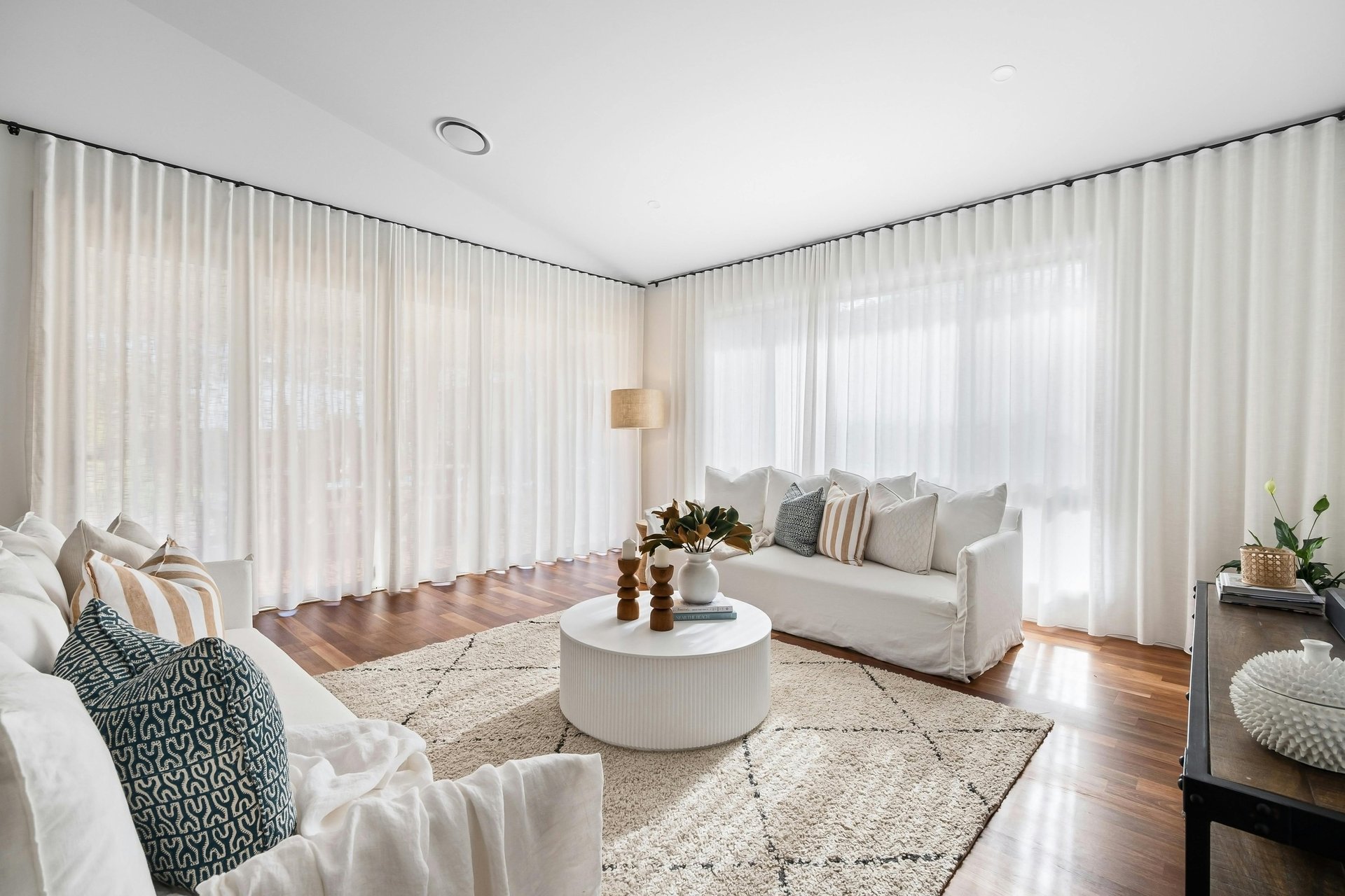 a blue chair and a yellow lamp in a white room