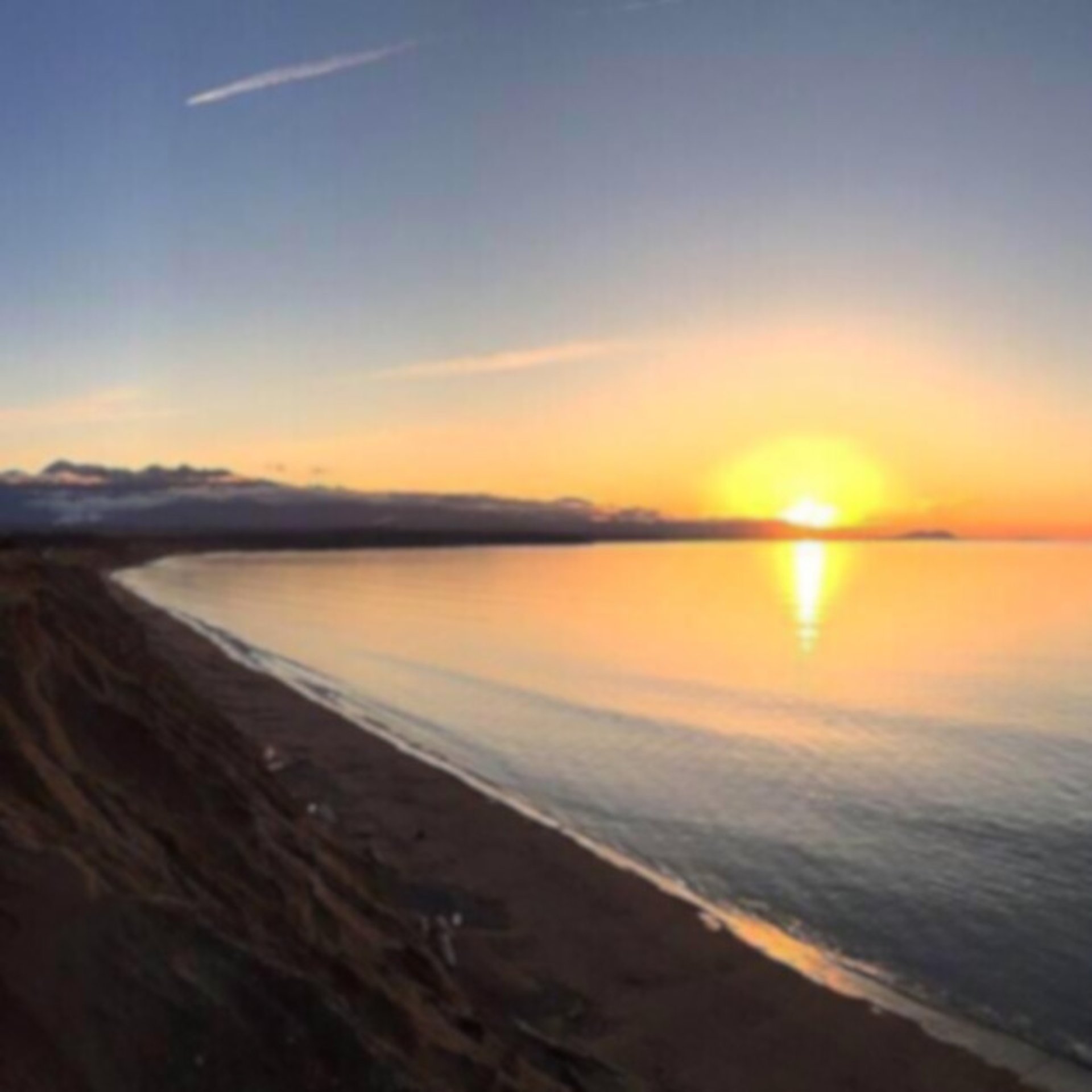 an abstract photo of a curved building with a blue sky in the background