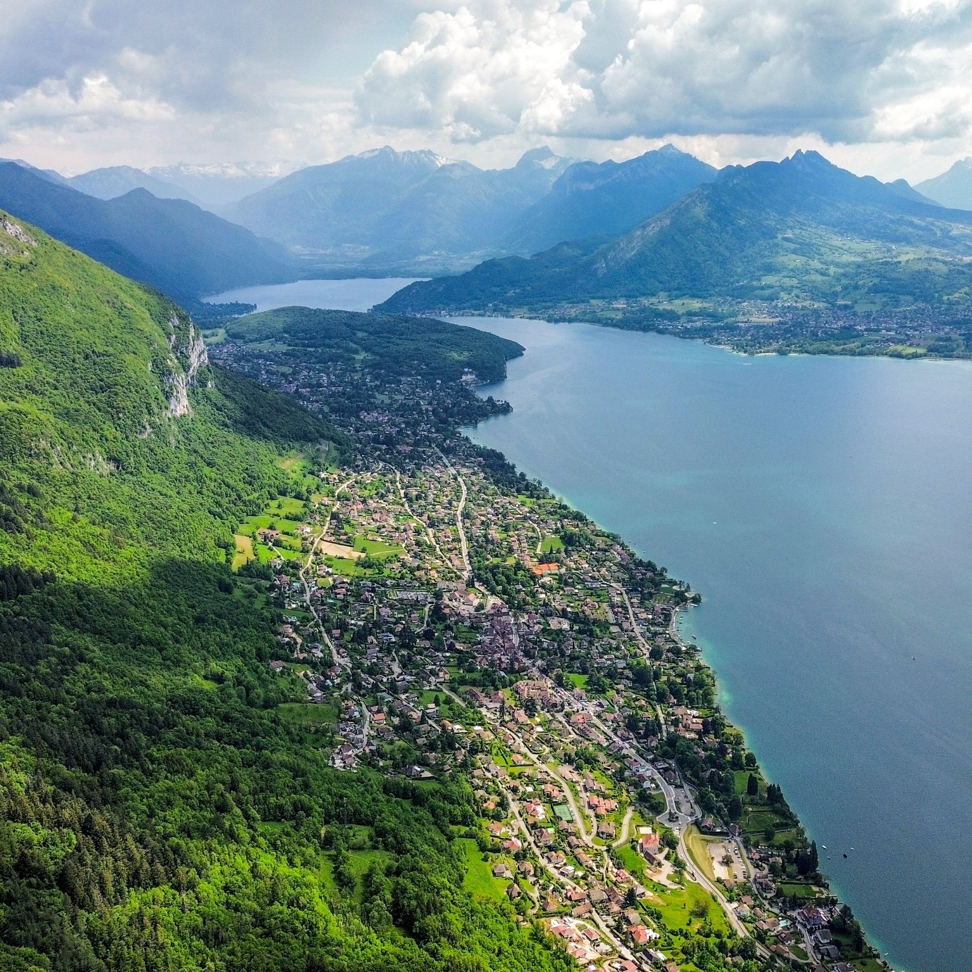 brown concrete building near mountain under blue sky during daytime
