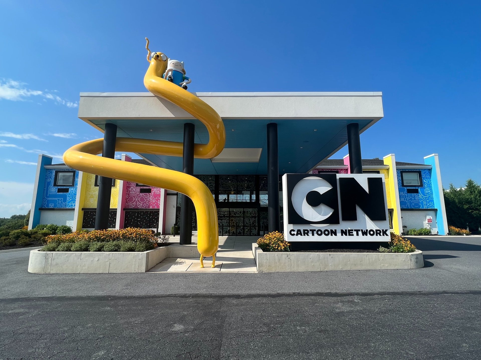 an abstract photo of a curved building with a blue sky in the background