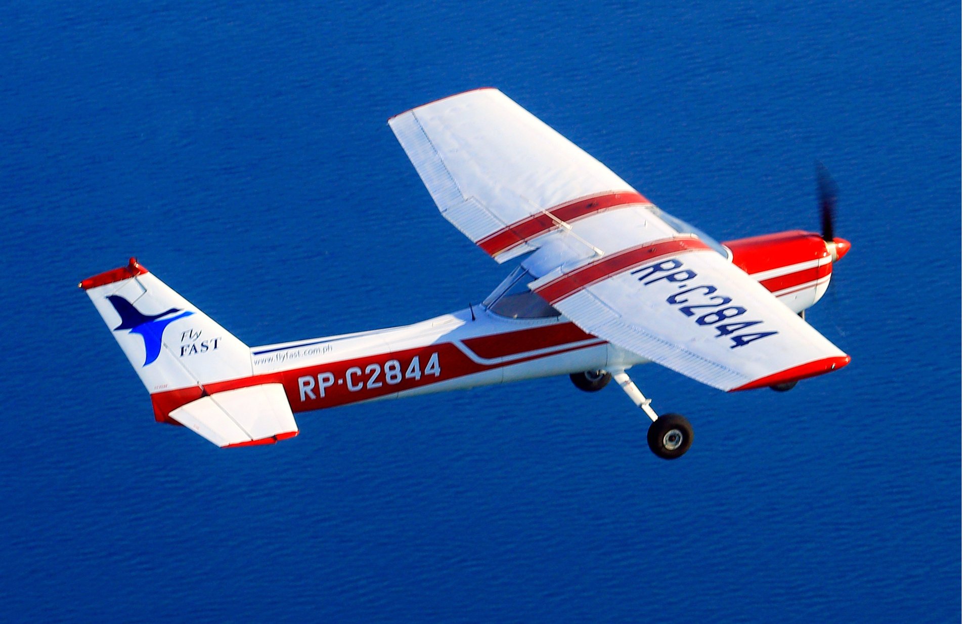 white and red airplane under blue sky during daytime