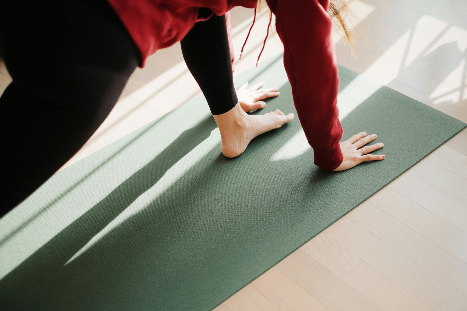 Woman doing pilates on a reformer machine.