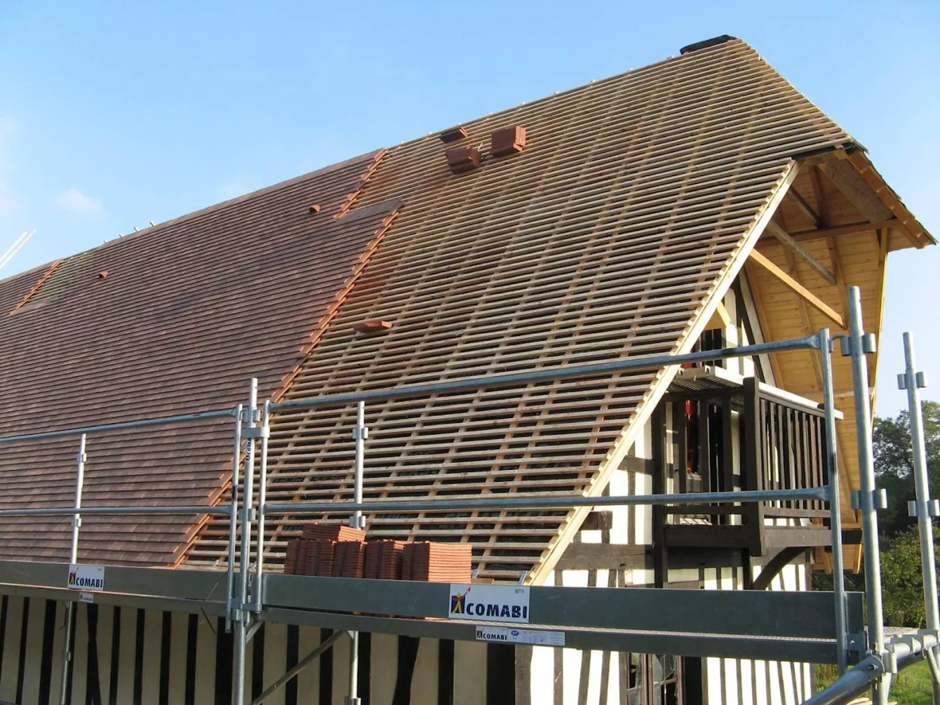 a man working on a roof with a power drill