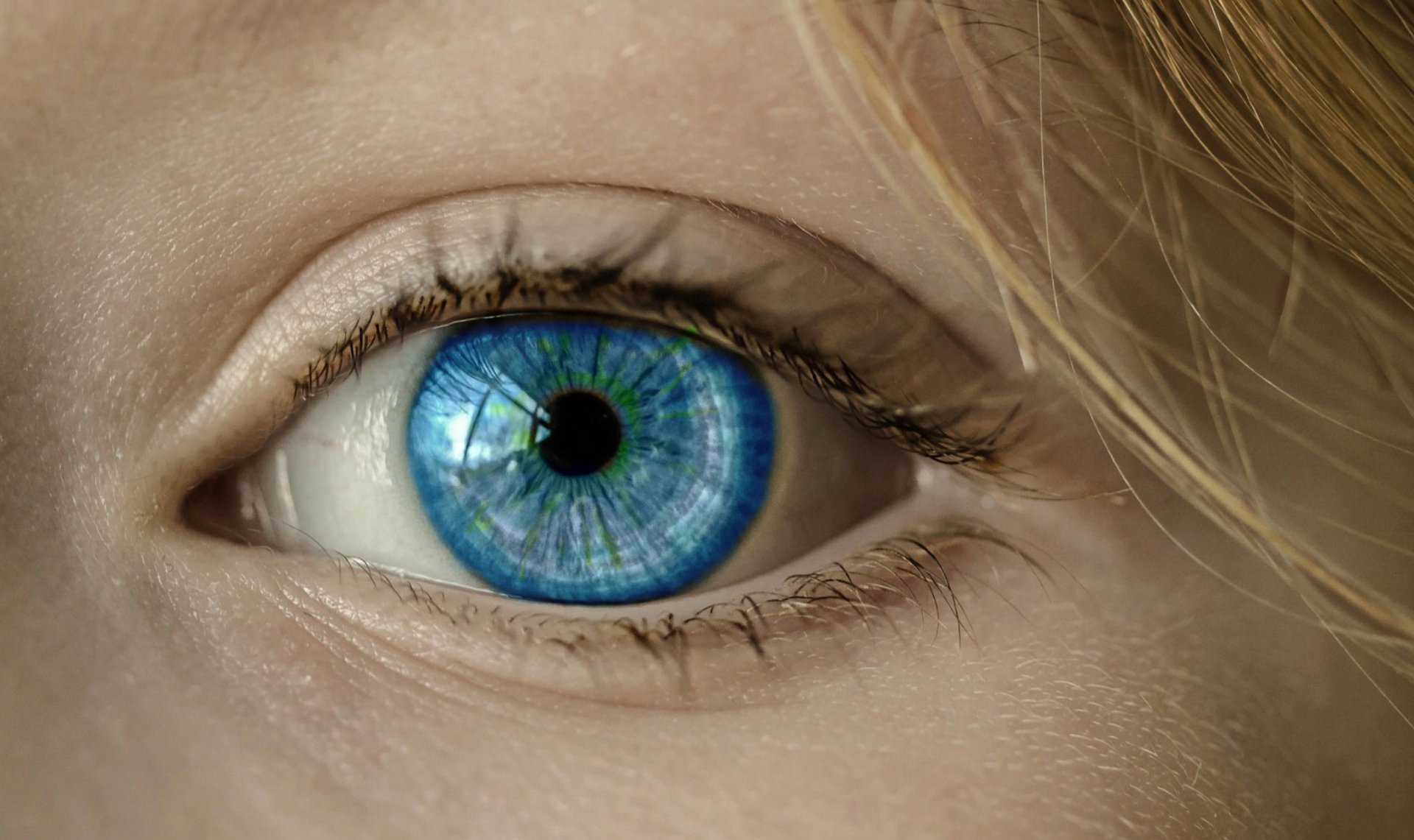 a close up of a person's green eye