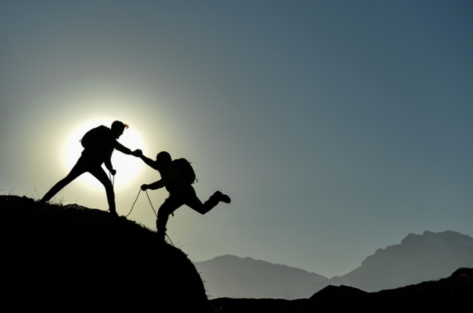 an abstract photo of a curved building with a blue sky in the background
