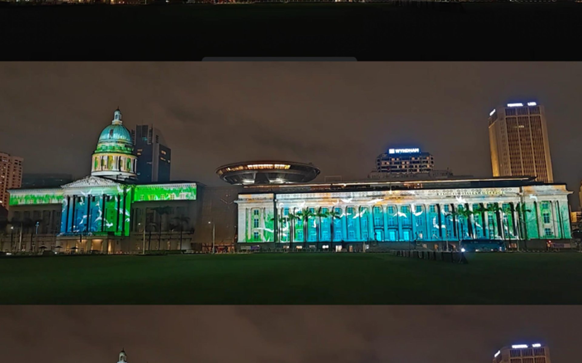 an abstract photo of a curved building with a blue sky in the background
