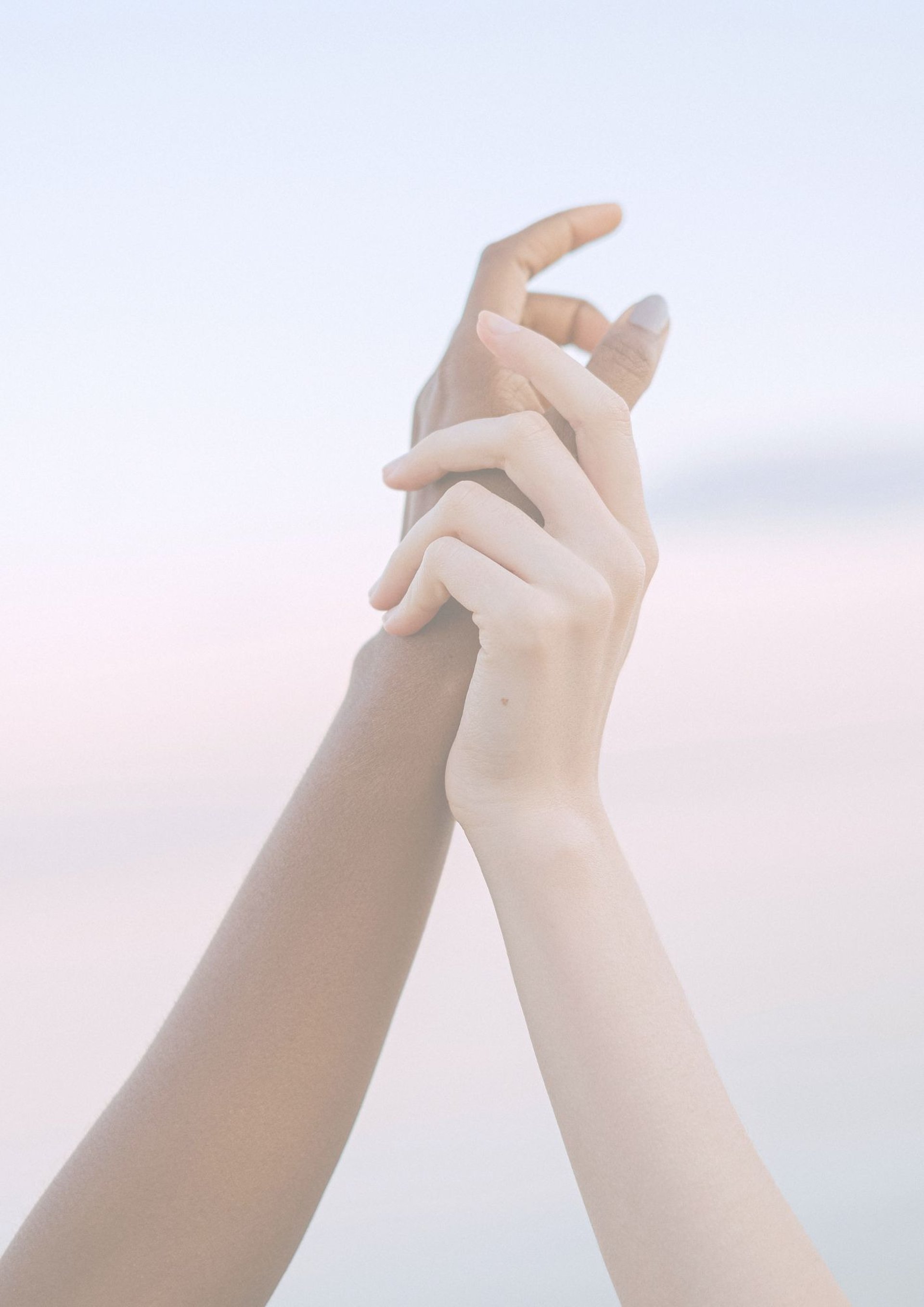 Diverse hands bump fists in solidarity.