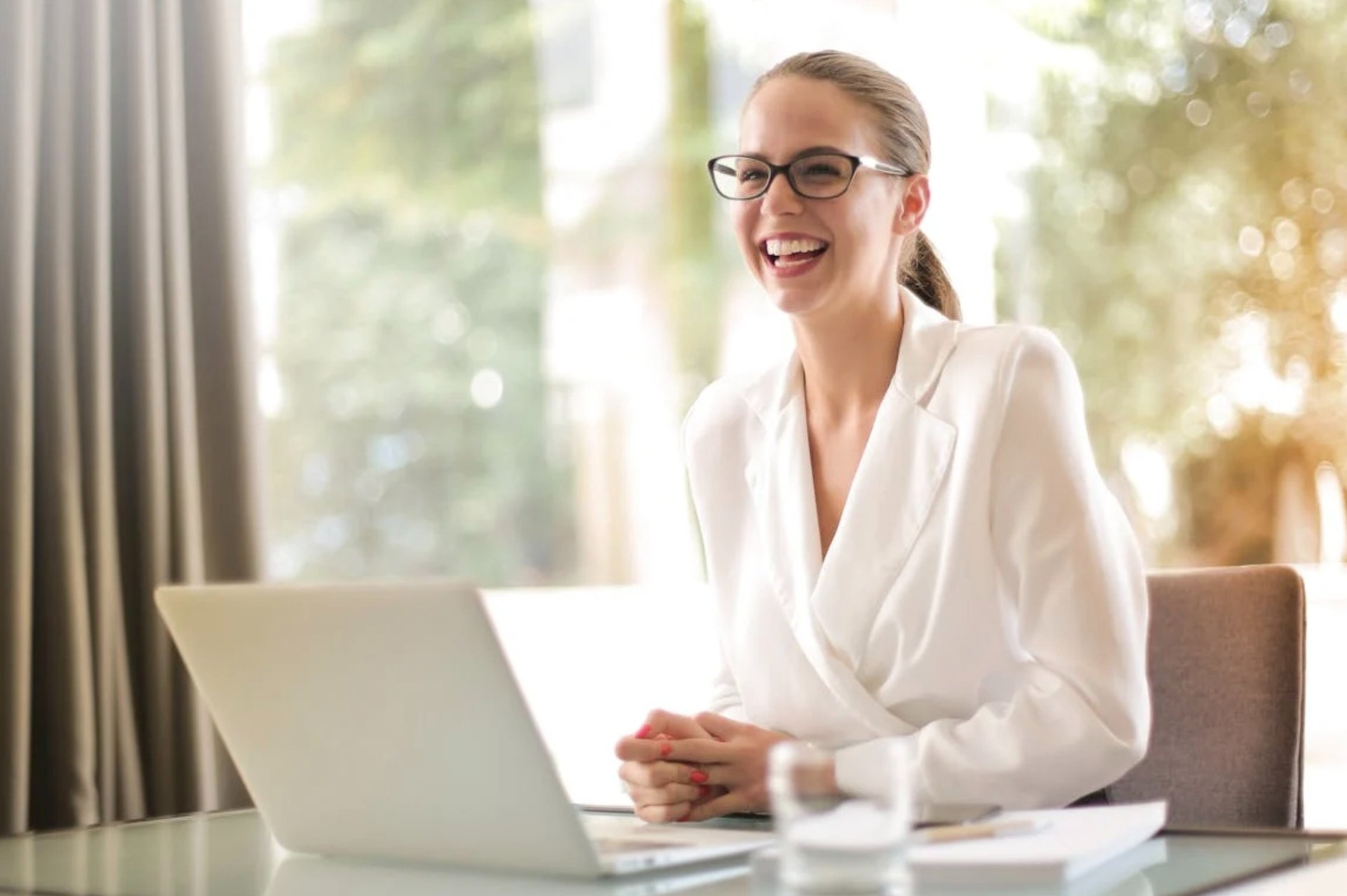 a person sitting on a table with a laptop
