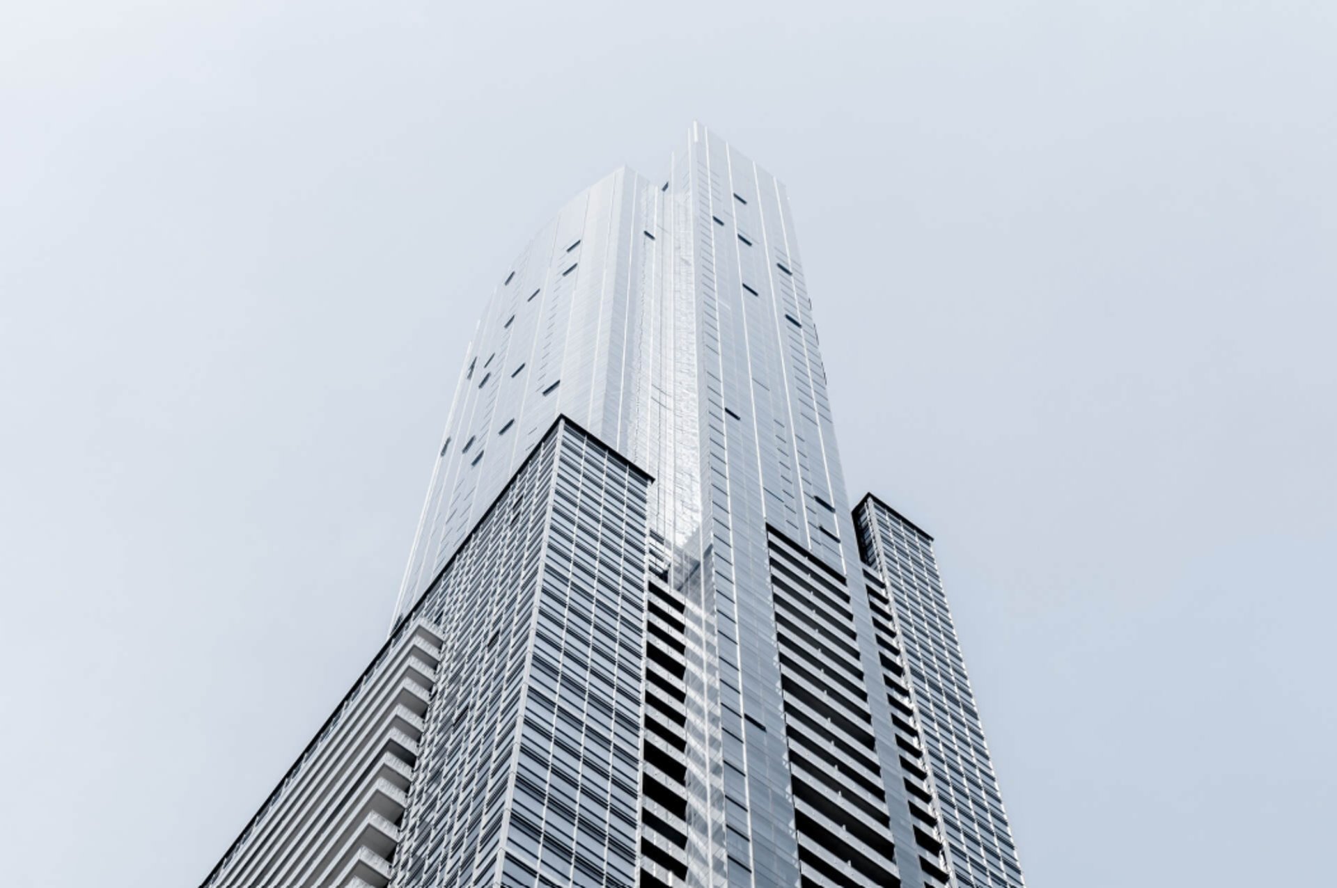 an abstract photo of a curved building with a blue sky in the background