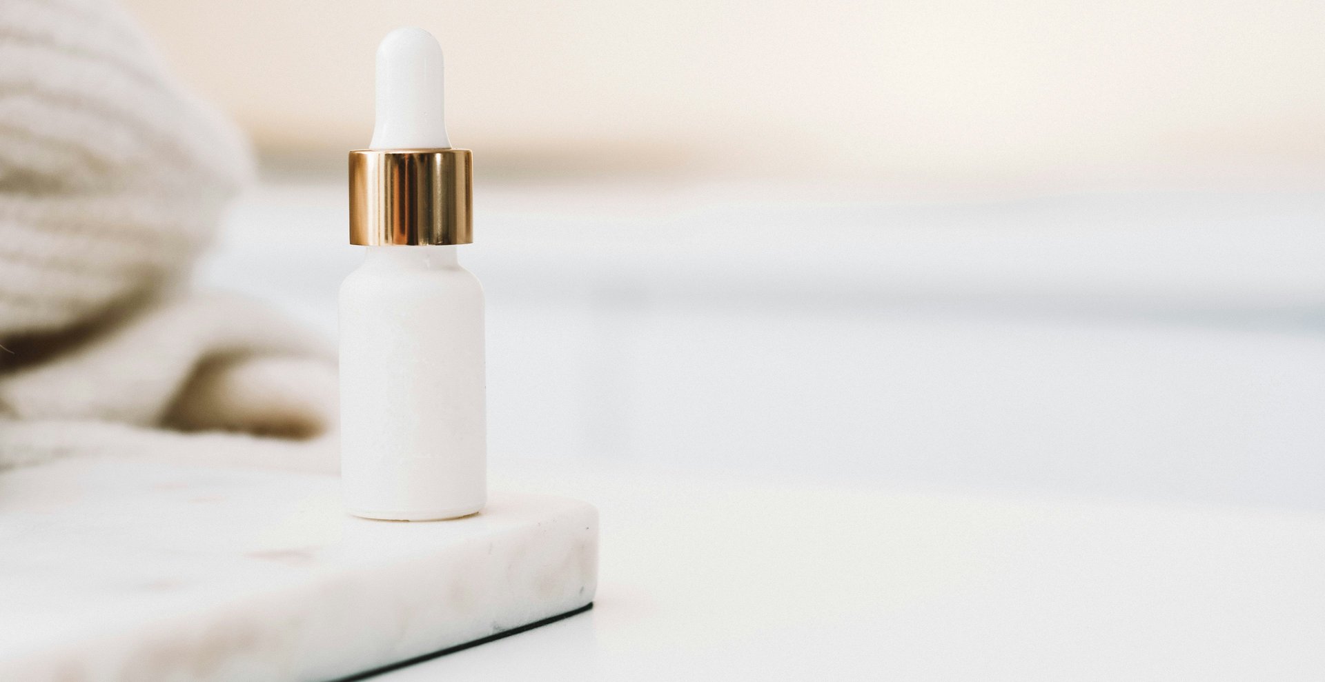 white drop bottle on white surface