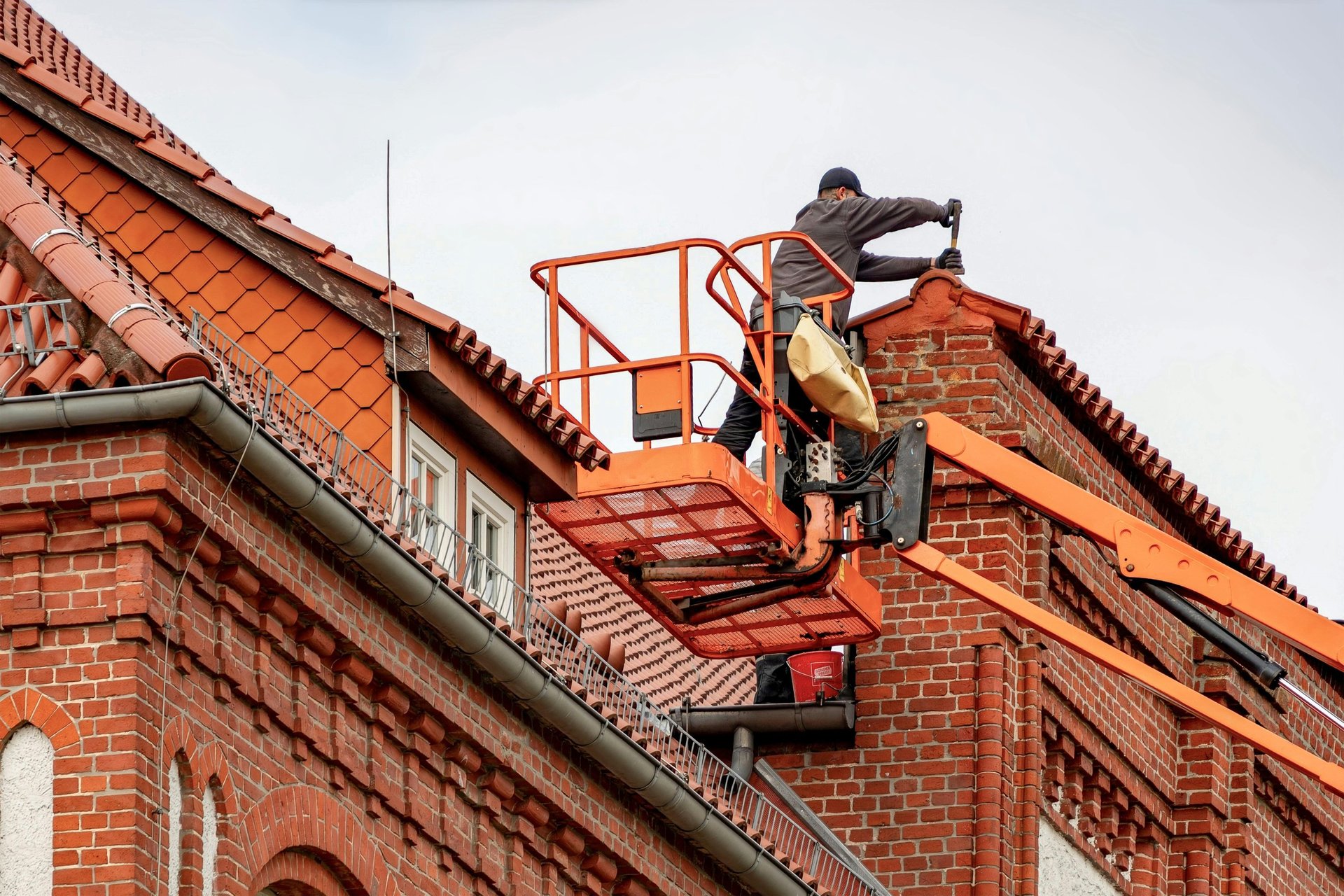 A red tiled roof with a ladder.