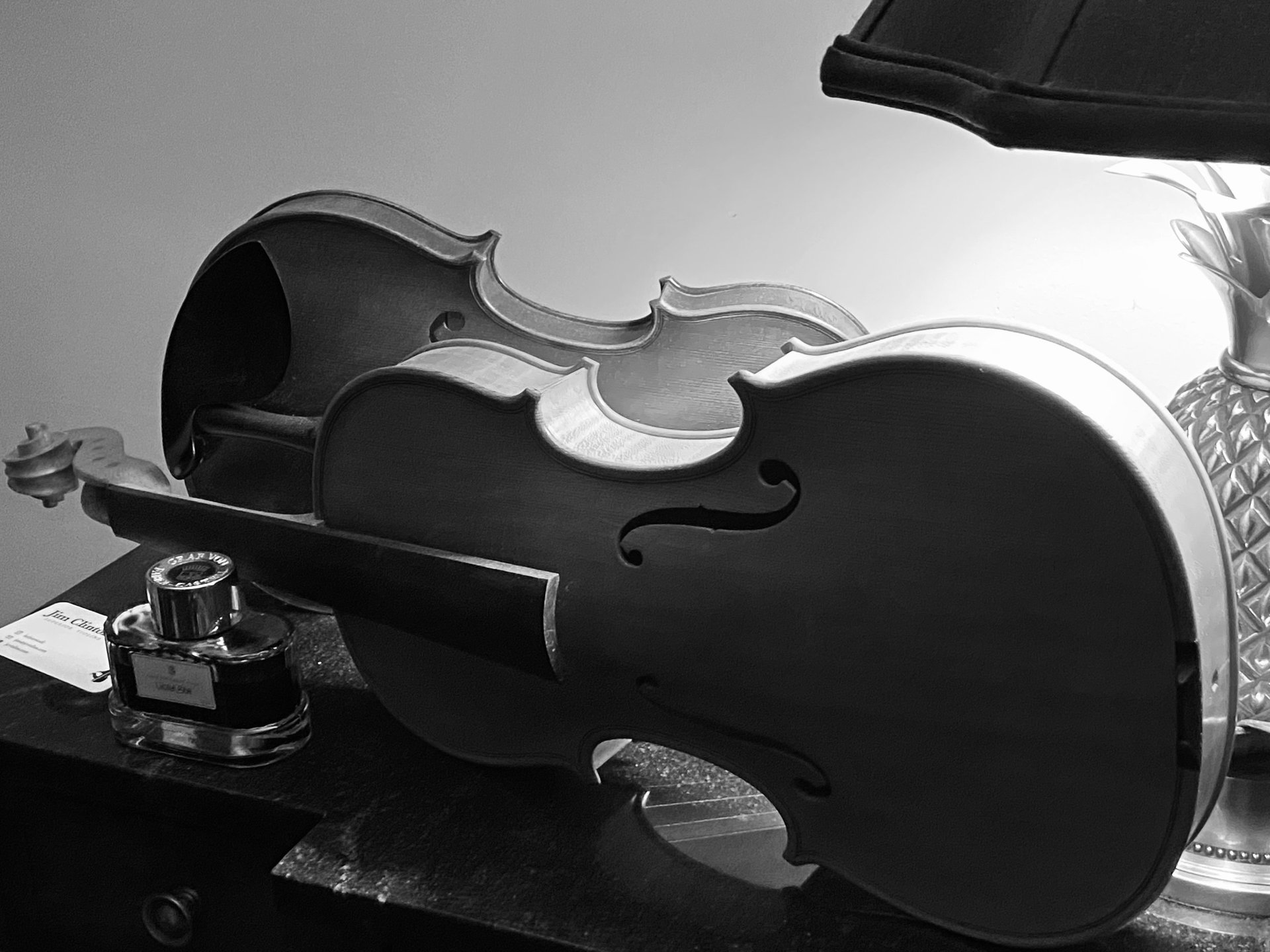 Violin scroll rough-carved, in the white, with side lighting