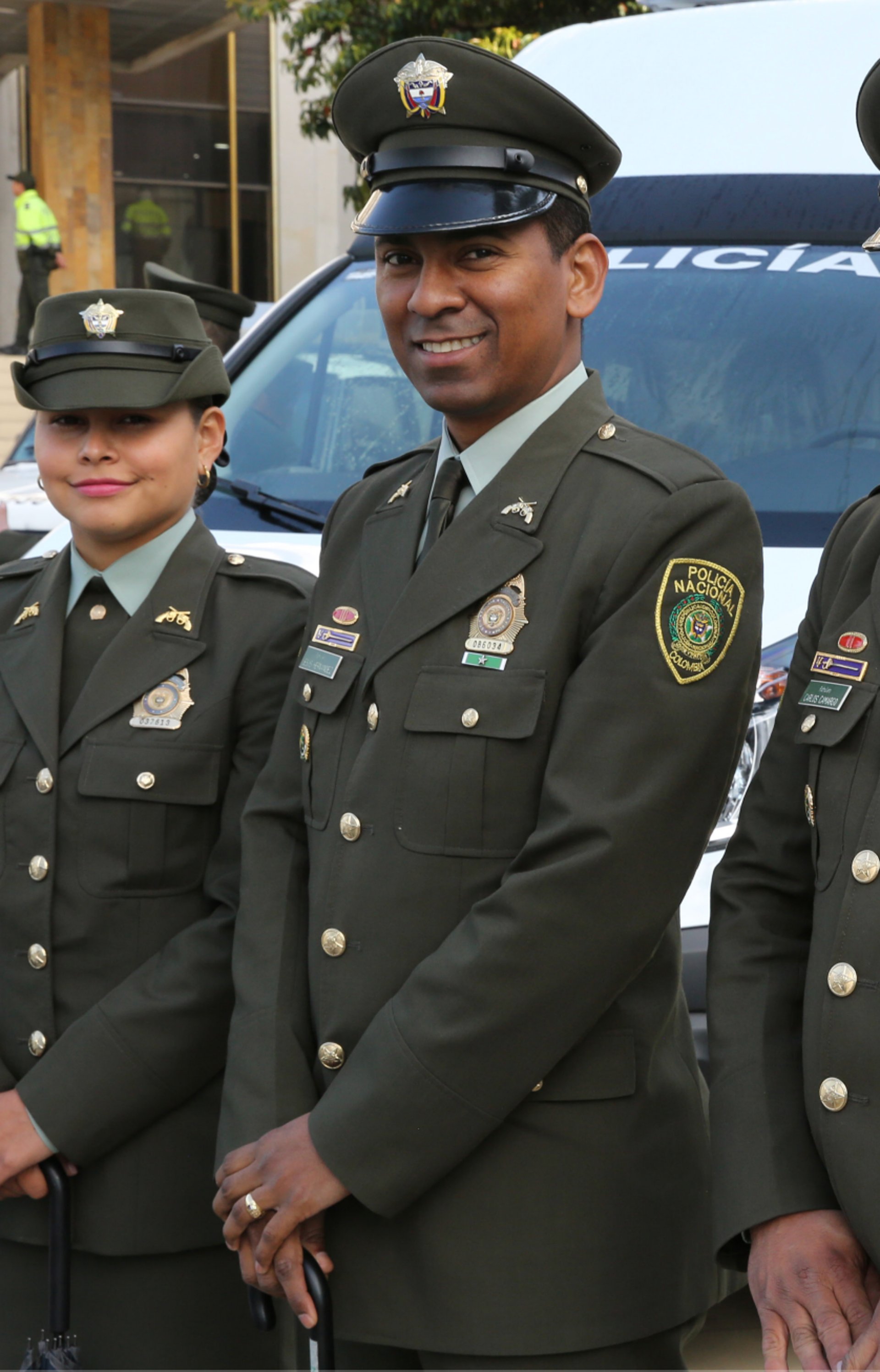 four person hands wrap around shoulders while looking at sunset