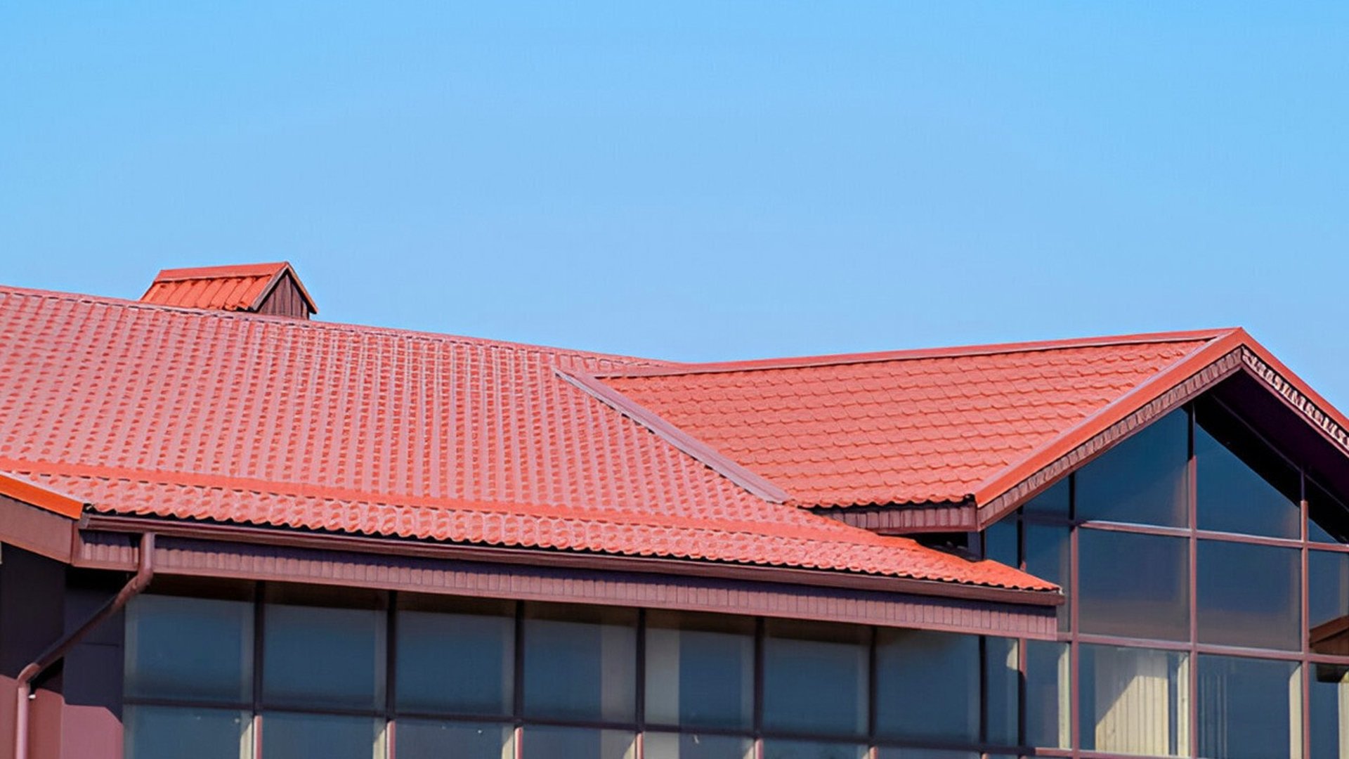an abstract photo of a curved building with a blue sky in the background