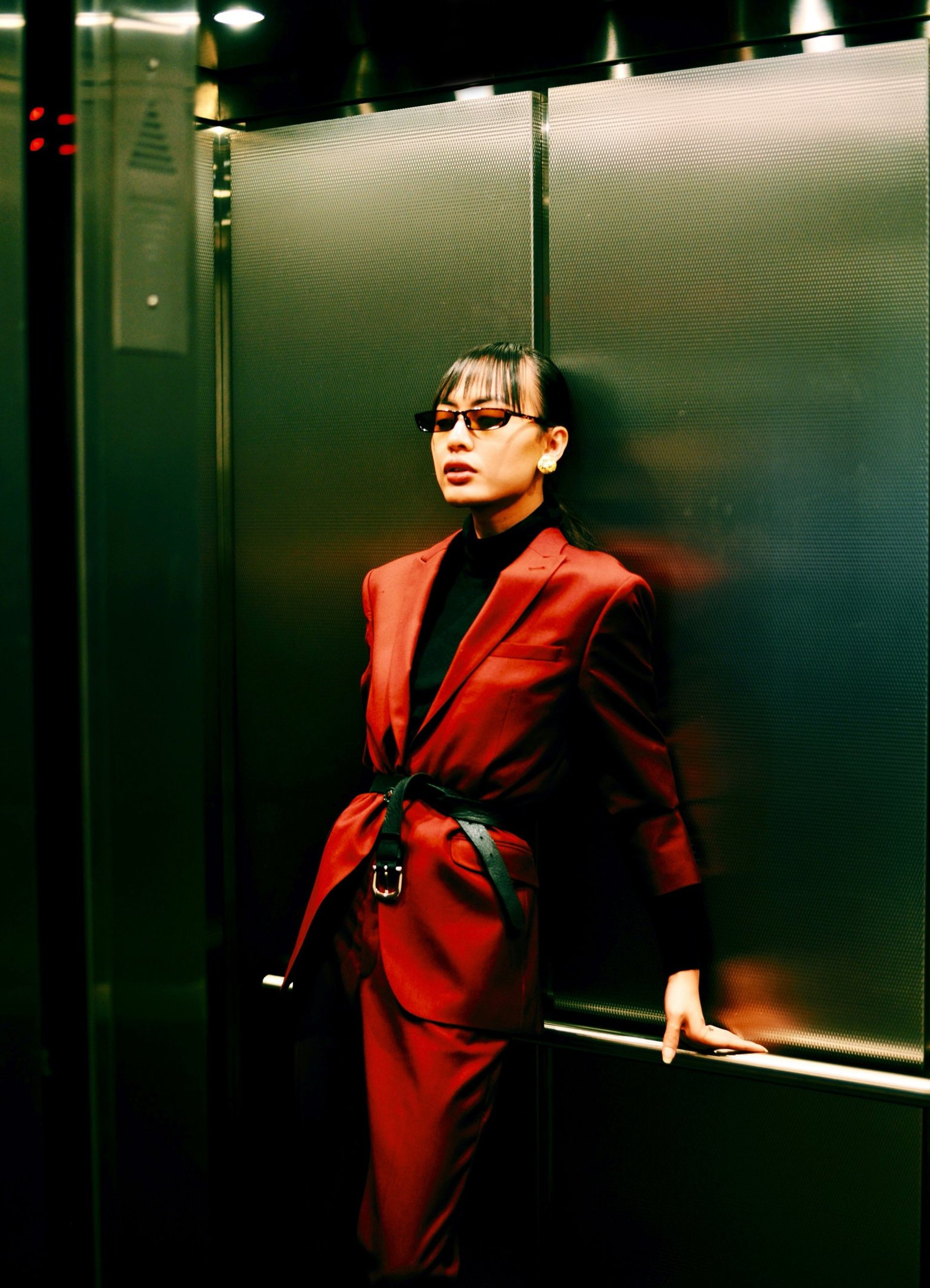 woman in red blazer in elevator