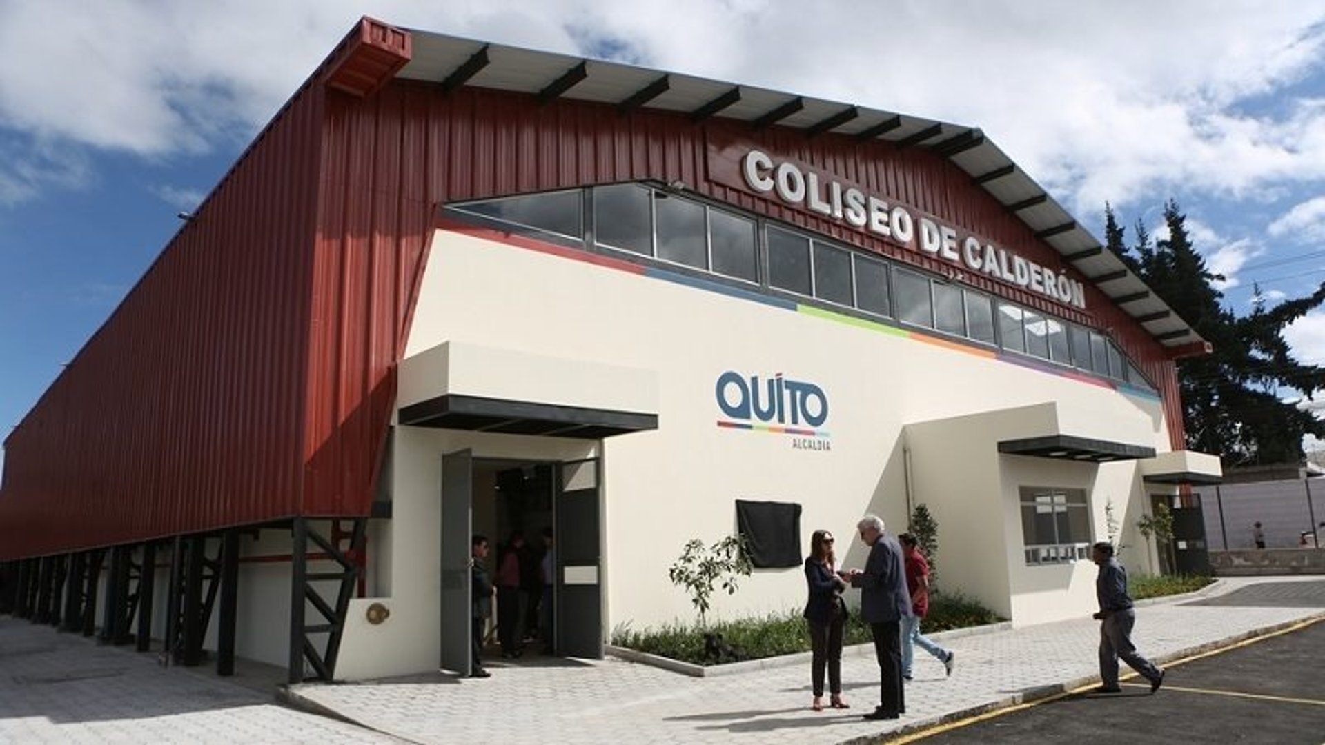 an abstract photo of a curved building with a blue sky in the background
