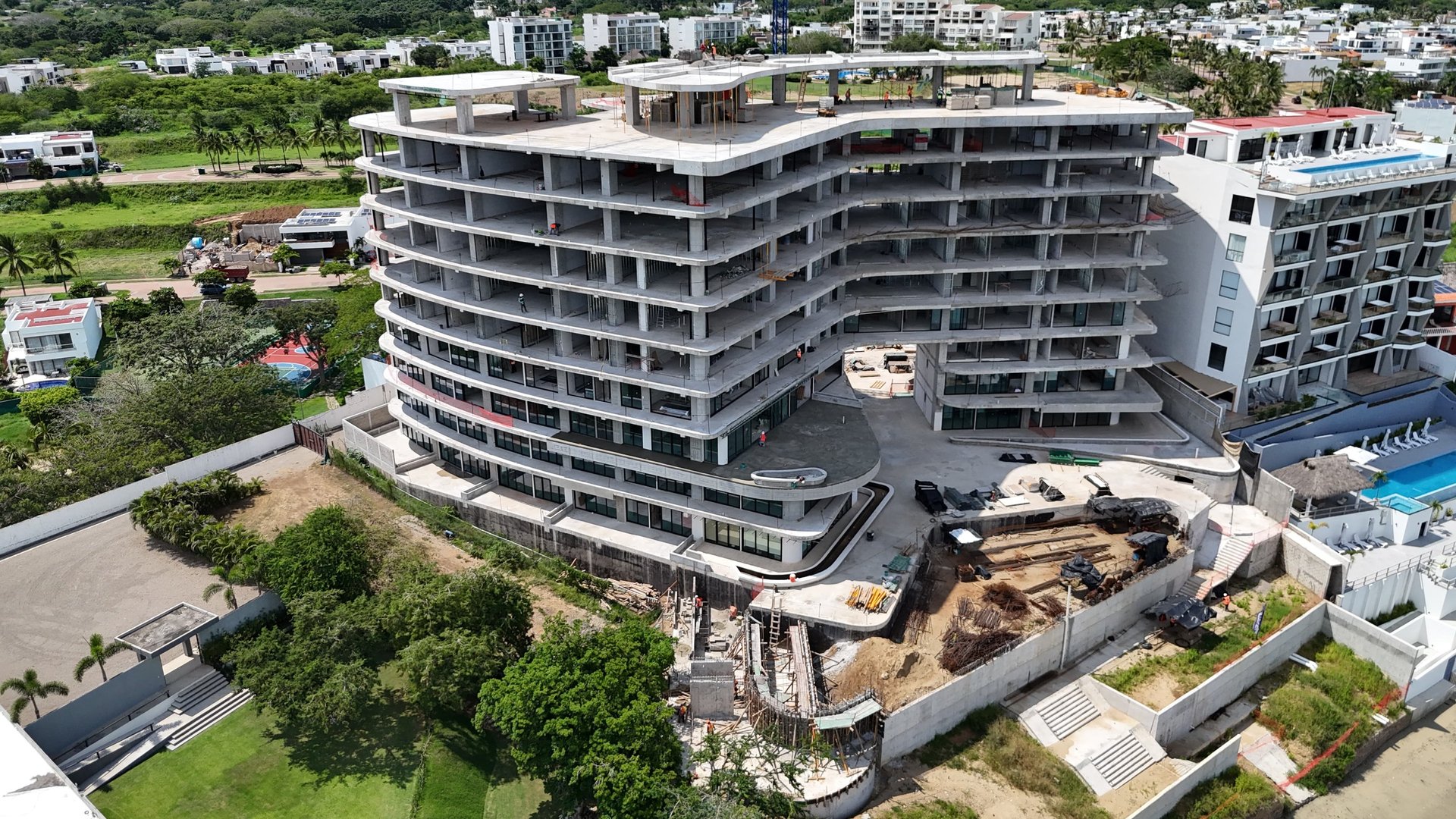 an abstract photo of a curved building with a blue sky in the background