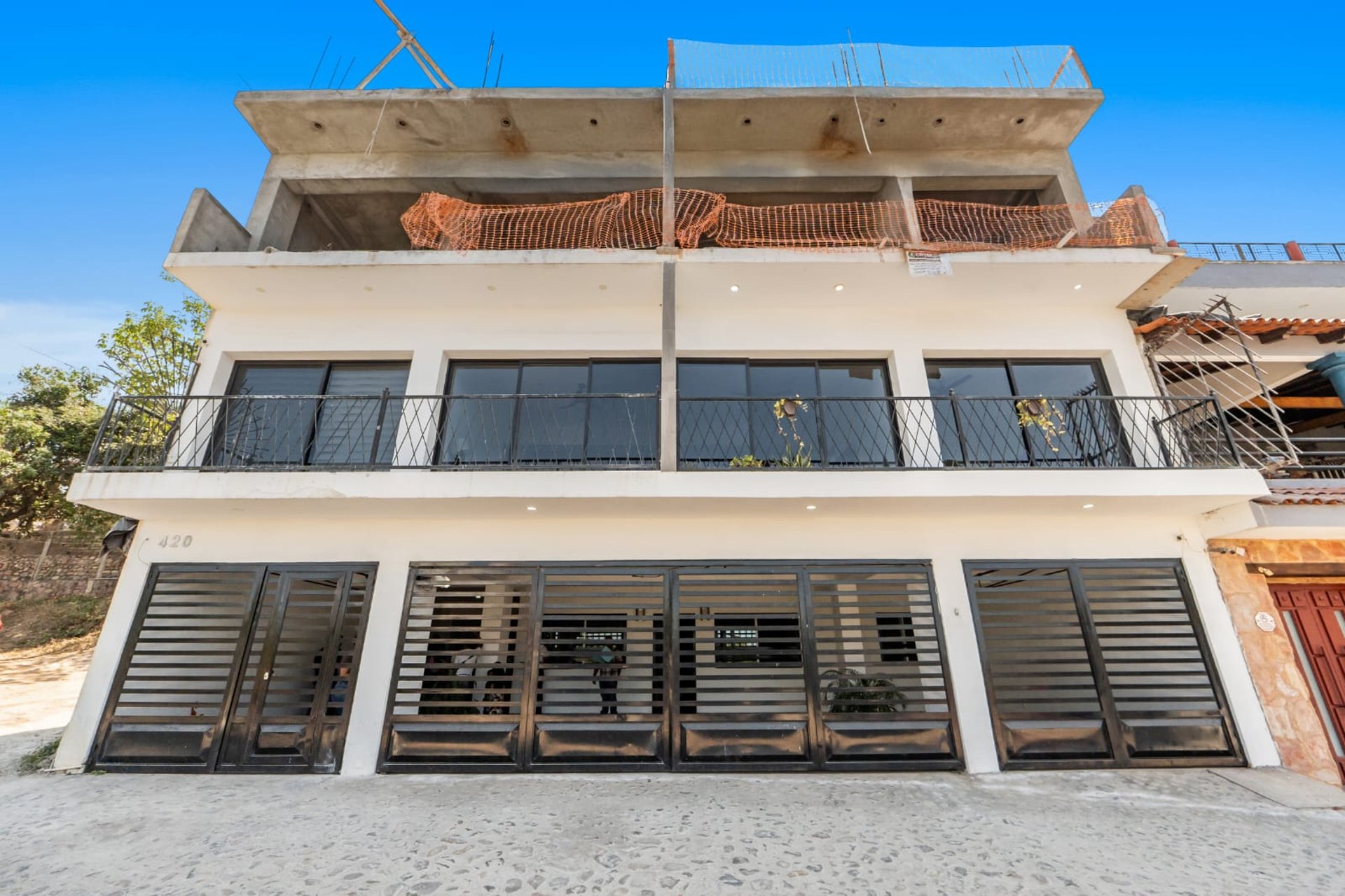 an abstract photo of a curved building with a blue sky in the background