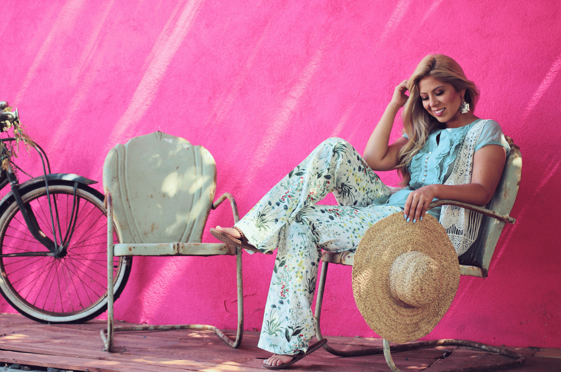 a woman sitting on a chair next to a bike